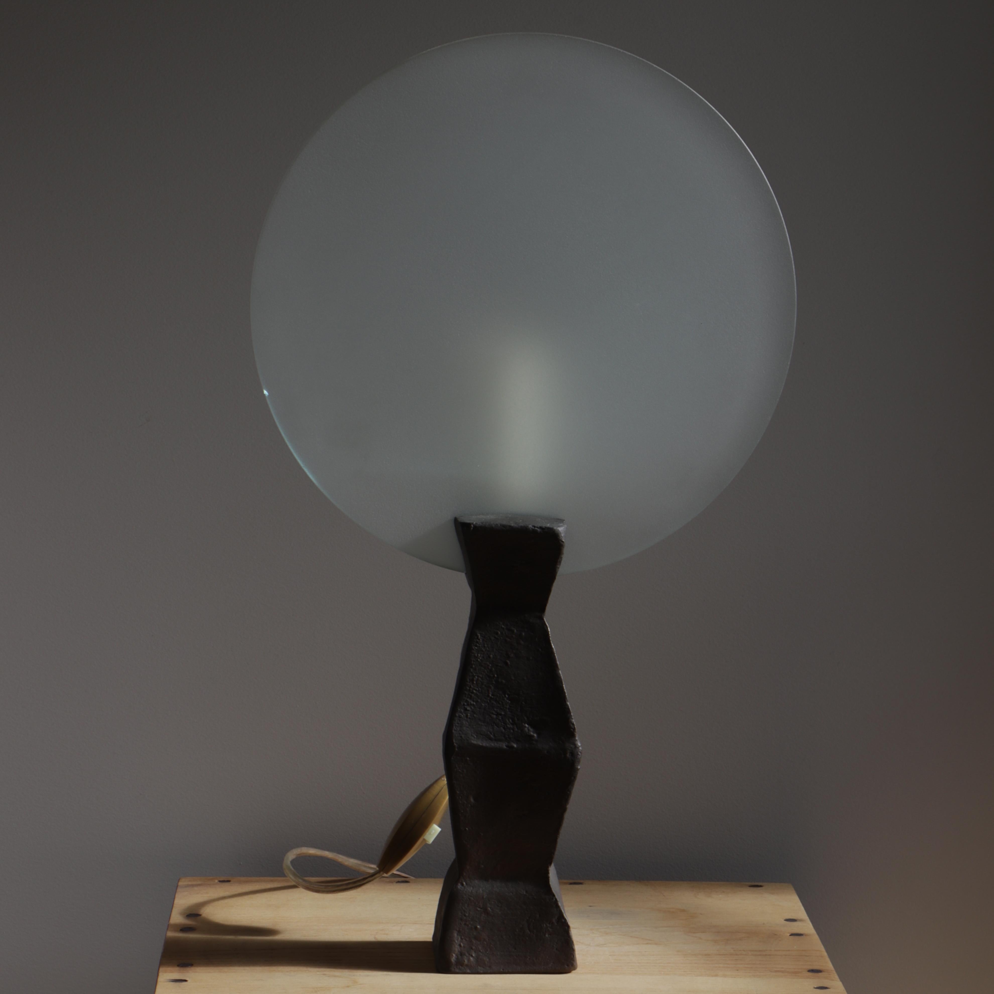 This lamp named « Lune », (moon), « En attendant les barbares » edition was designed by Elizabeth Garouste and Mattia Bonetti and dates from around 1983. It is composed of a bronze base, a flameless candle light and a circular frosted glass bulb