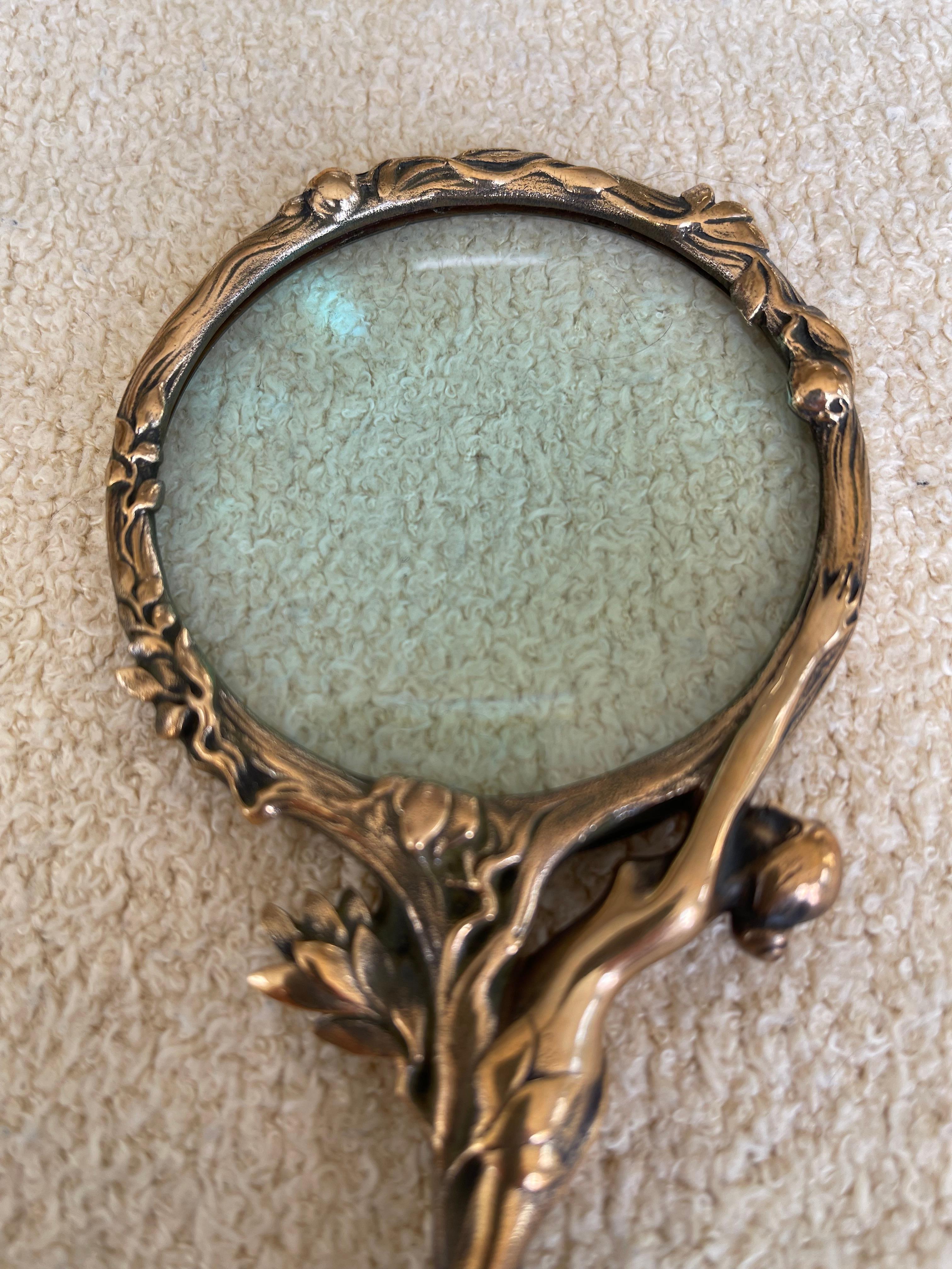  This lovely high quality magnifying glass makes a perfect piece for the art nouveau lover, or anyone who wants to hold a beautiful object when trying to magnify something. Note the nude wrapped around glass, a whimsical addition to be sure.
  Hard