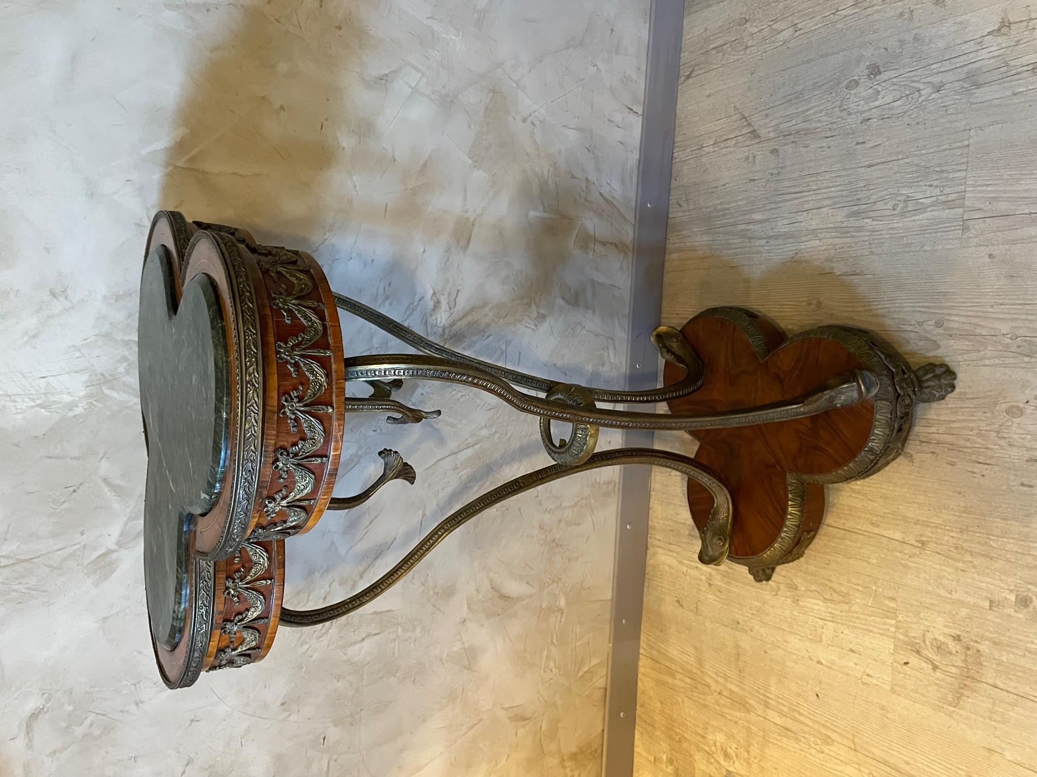 Very original 20th century column from the Empire style made with walnut veneer and bronze. The top is a beautiful green marble. 
The bronze uprights represent dolphin's head. Bronze flower bouquet all around the top. Also bronze lion's paws base.