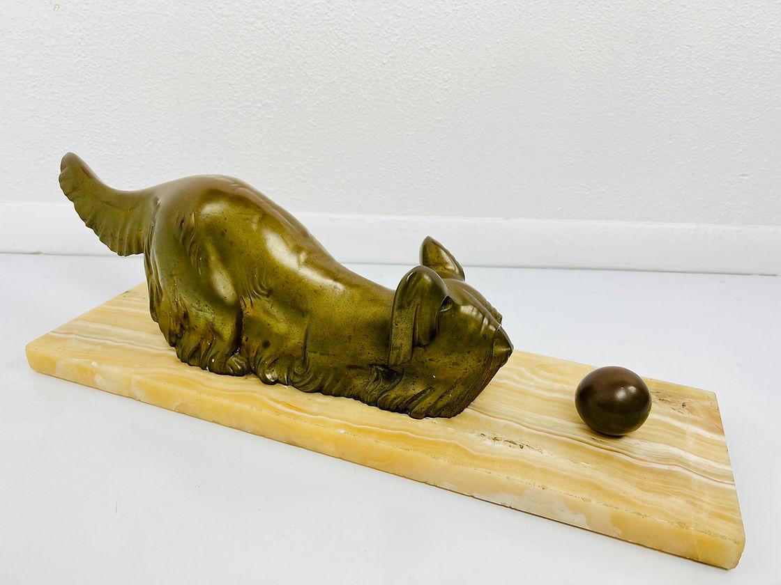 Antique bronze sculpture, depicting a crouched Yorkshire terrier with ball. Nicely chiseled bronze work o a marble base.
