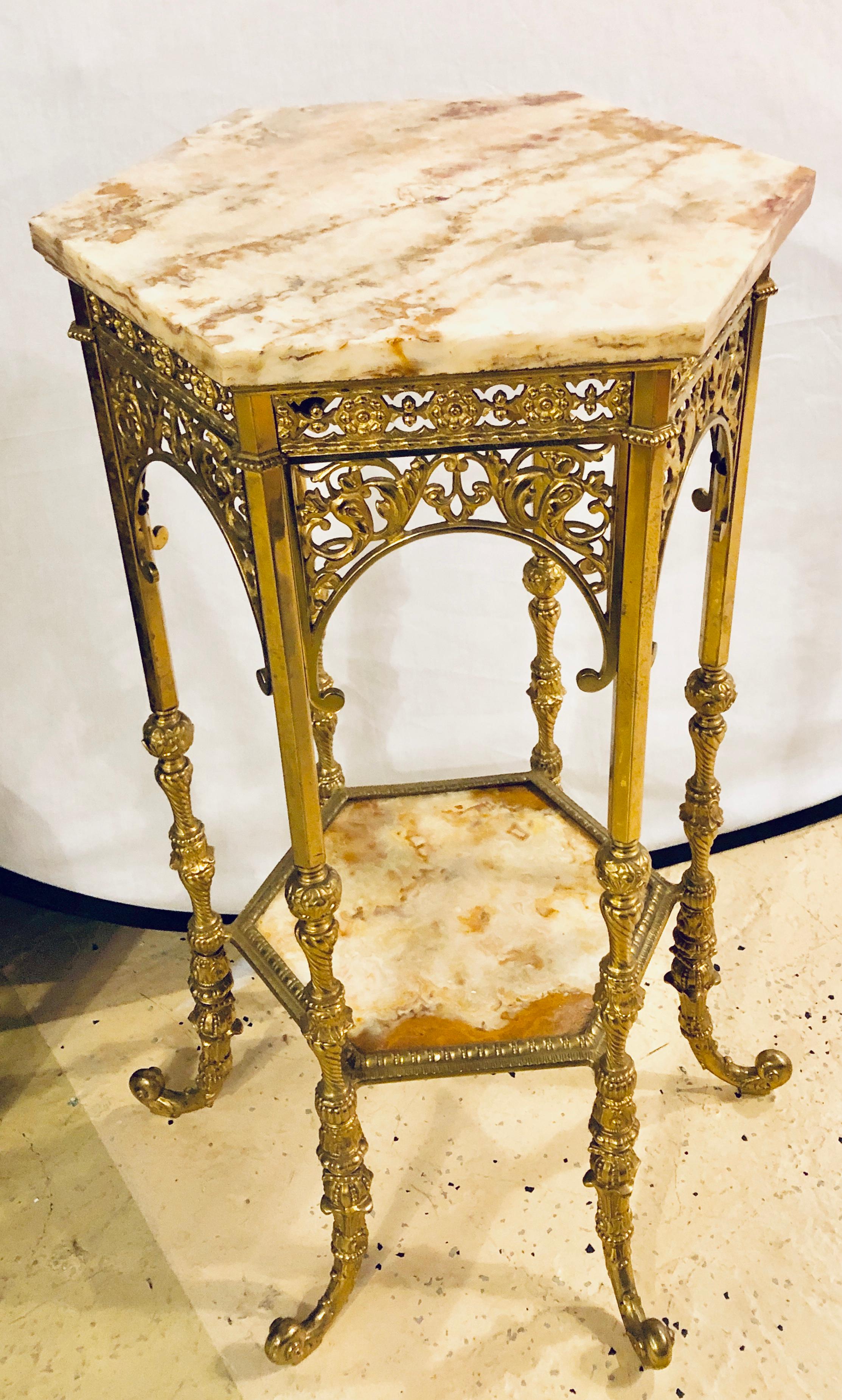 A bronze marble-top two-tier pedestal or end table. The finely carved and detailed frame having two antiques marble tiers. The whole having a hexagonal (six sided) shape with carved roses and scroll design.