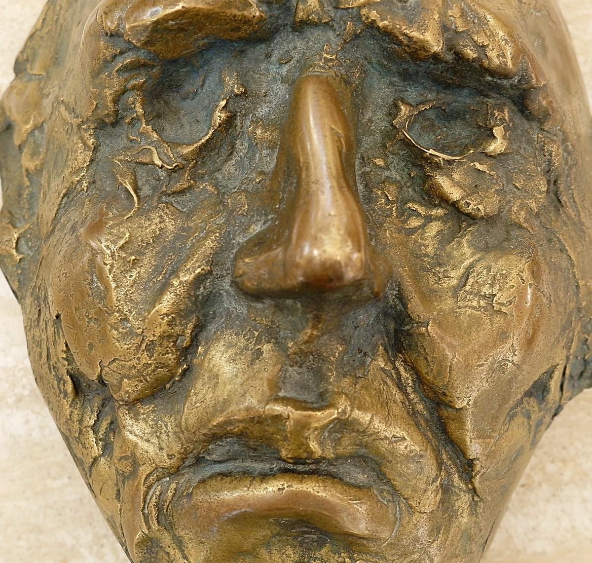 Bronze mask sculpture.