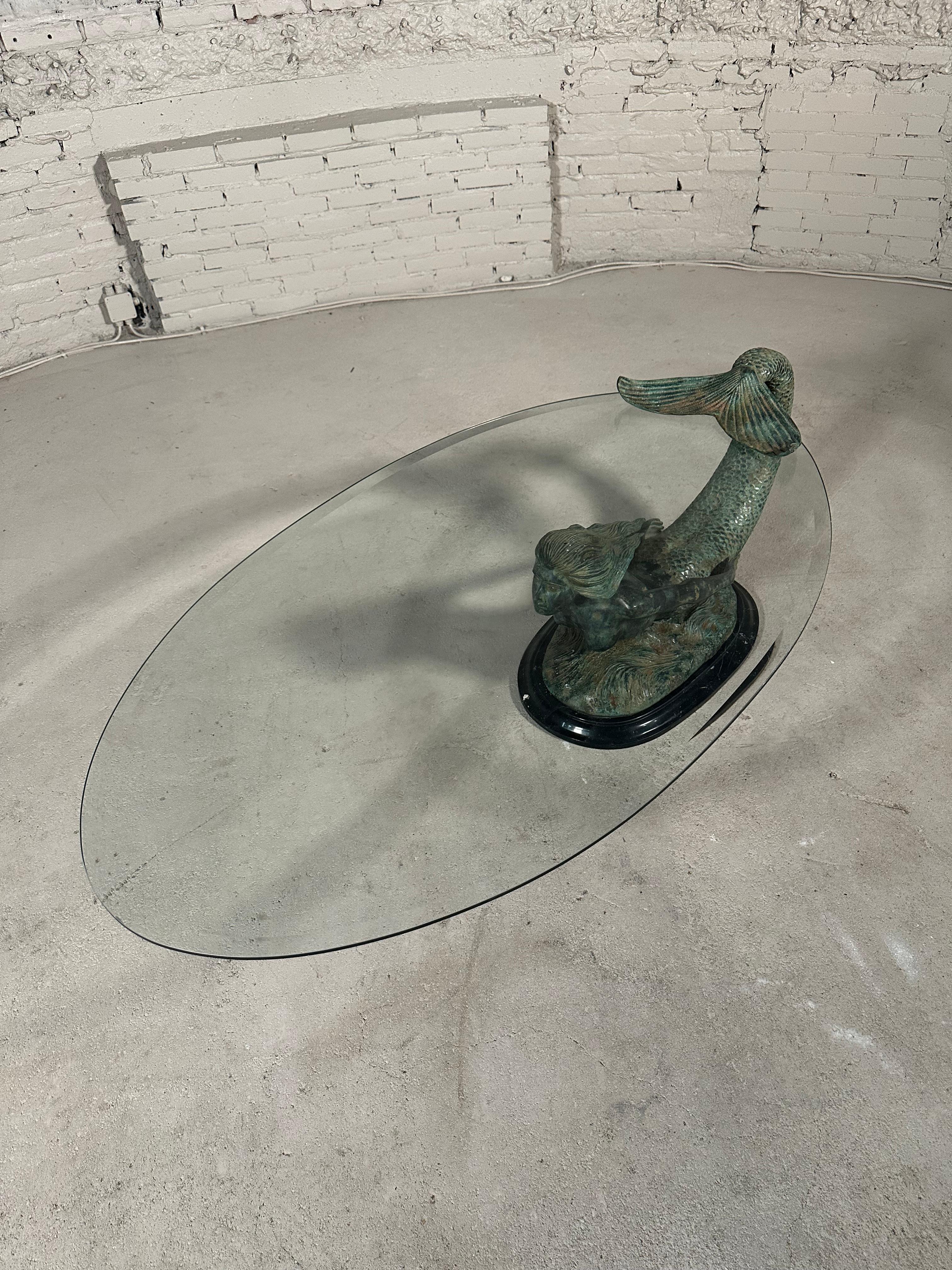 Bronze Mermaid Coffee Table, circa 1970's. 

This elegant coffee table features a faceted glass plate resting upon a sturdy mermaid bronze chassis with a stunning green patina. A massive marble plateau serves as the base for the mermaid sculpture.