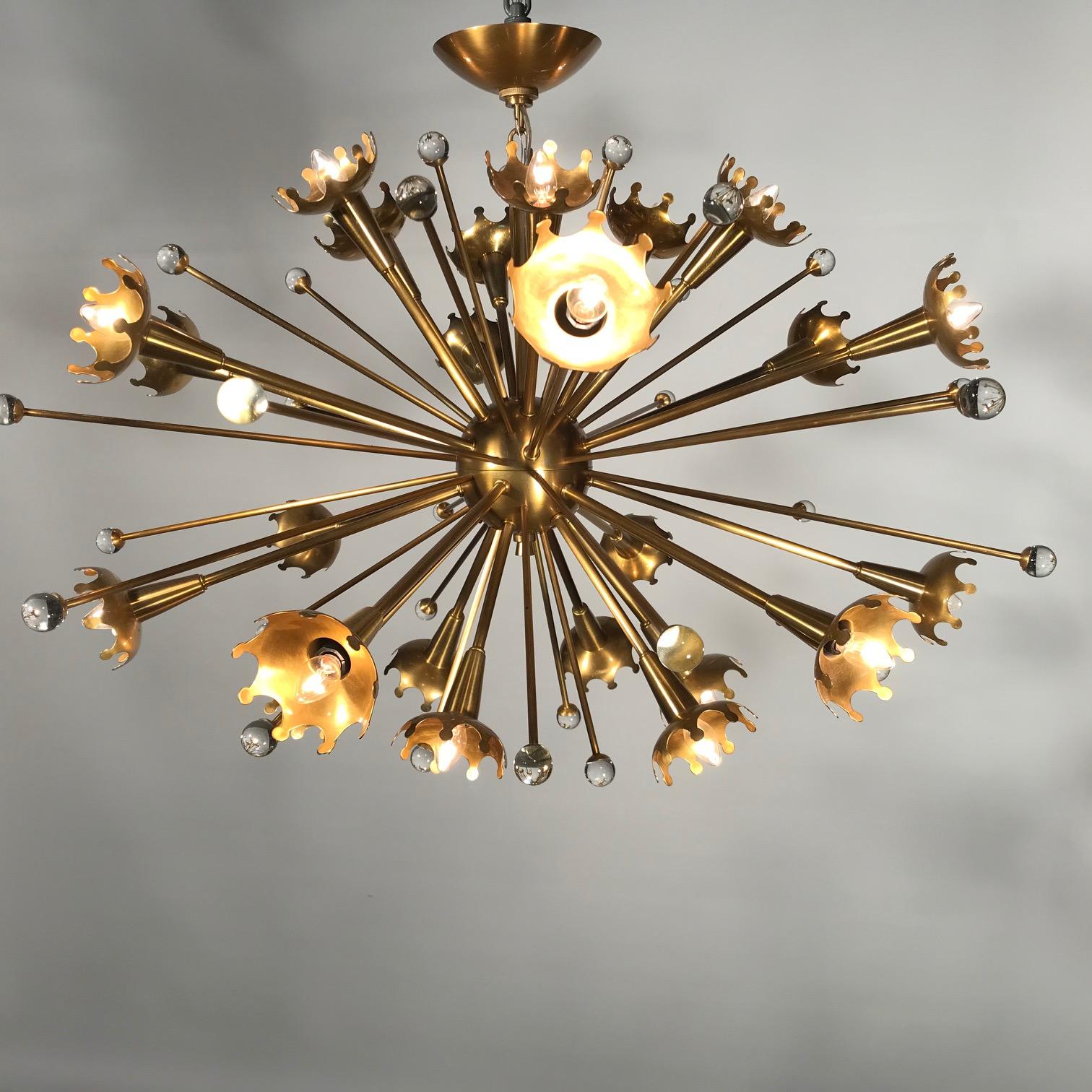 A classic twenty four light Sputnik chandelier by Jonathan Adler. At once futuristic and retro, funky and elegant, the Space Age-inspired Sputnik features numerous metal spokes shooting out from a central metal sphere, each accented by sparkling