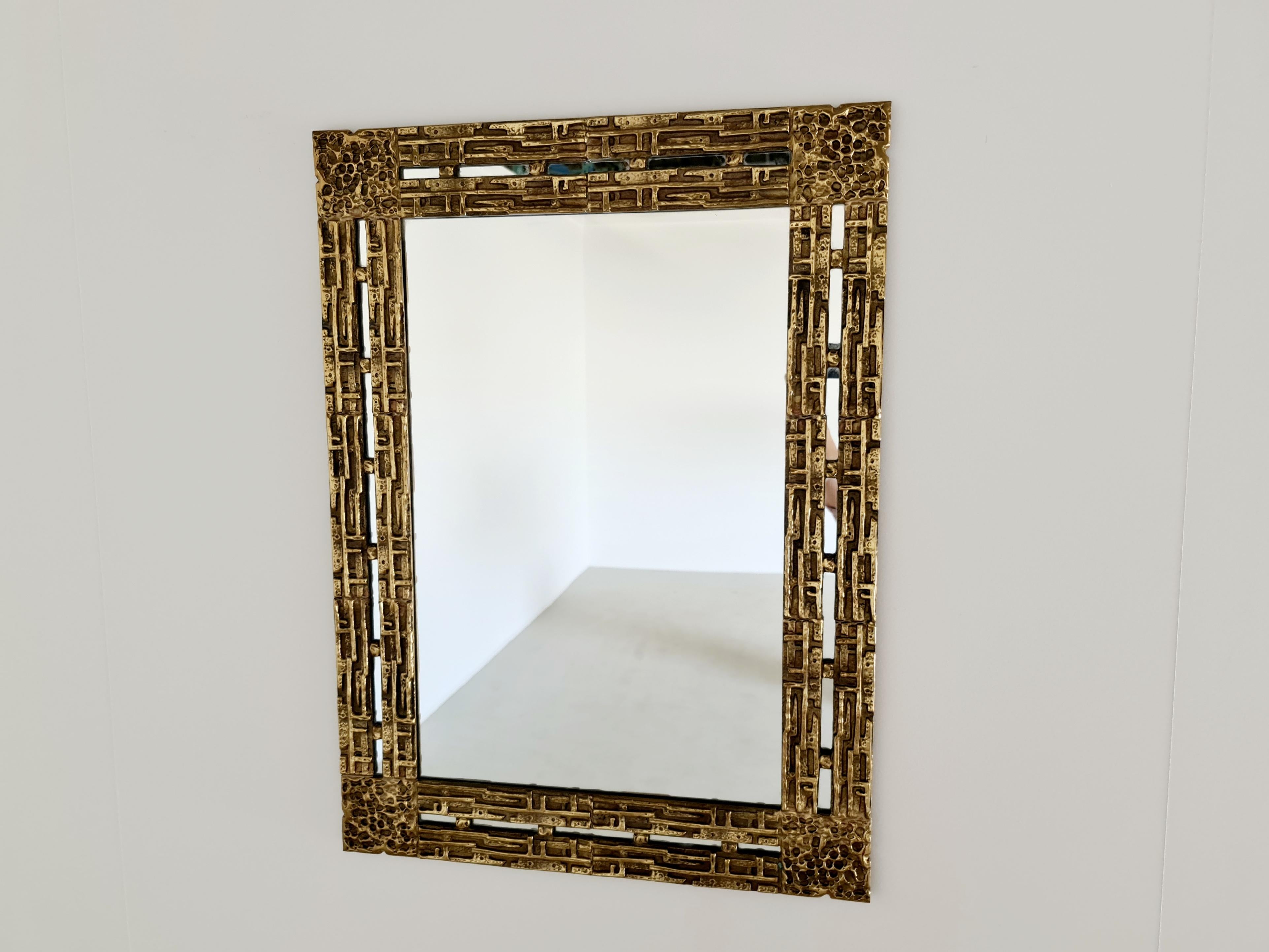 Brutalist wall mirror by Luciano Frigerio featuring a frame in cast bronze. This is model Desiree.
Luciano Frigerio is an Italian designer well active in the 1960s-70s. He designed elegant furniture in a brutalist chic style. The design is
