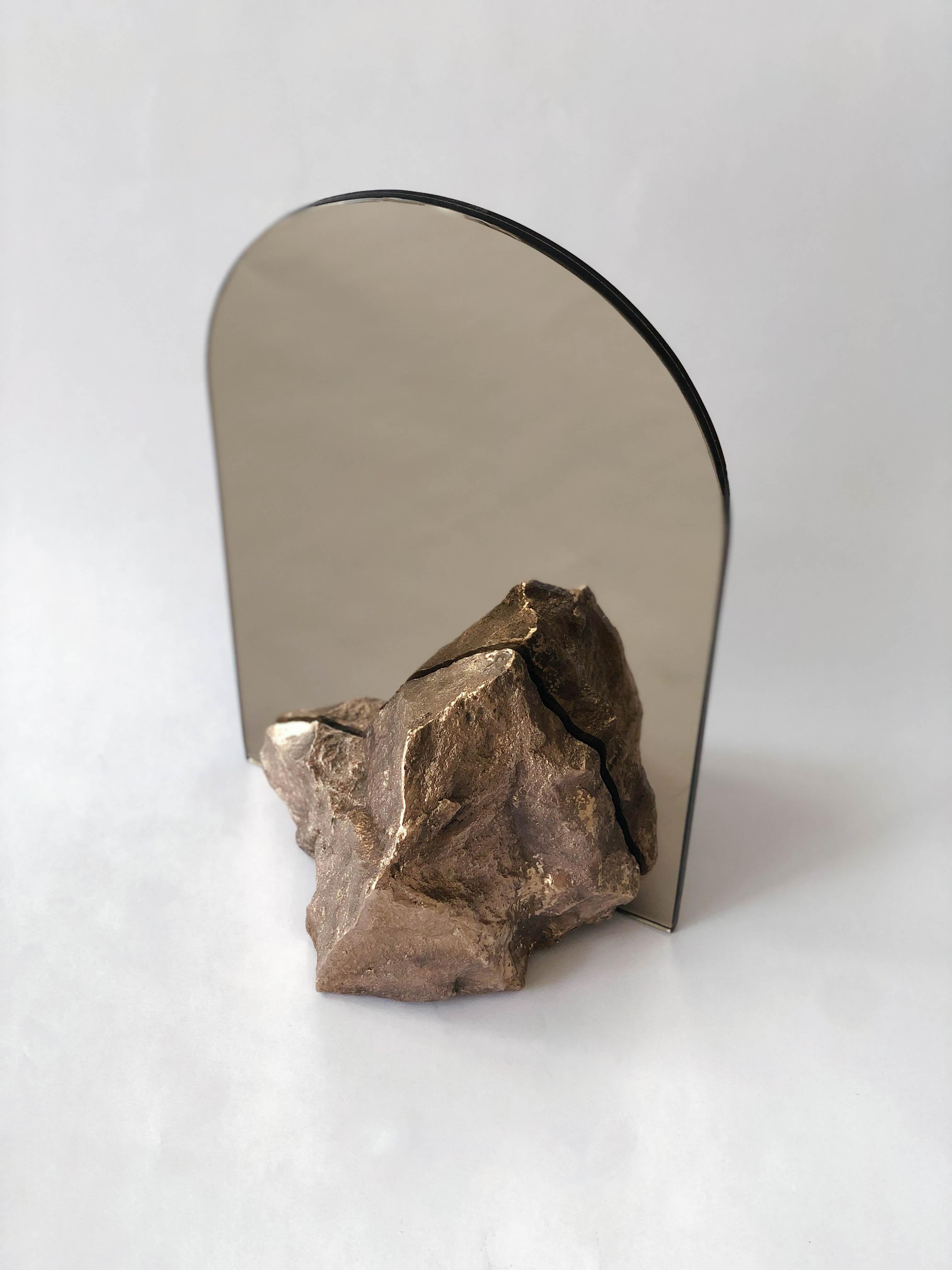 Bronze mirror - Dessislava Madanska
Onedesignspace
Title: Mirror, Mirror
Object: Desk Mirror
Dimensions: W 20 x D 20 x H 30 cm
Materials: double-sided mirror, copper tinted and stone shape
structure casted in bronze. Patinated.

Dessislava