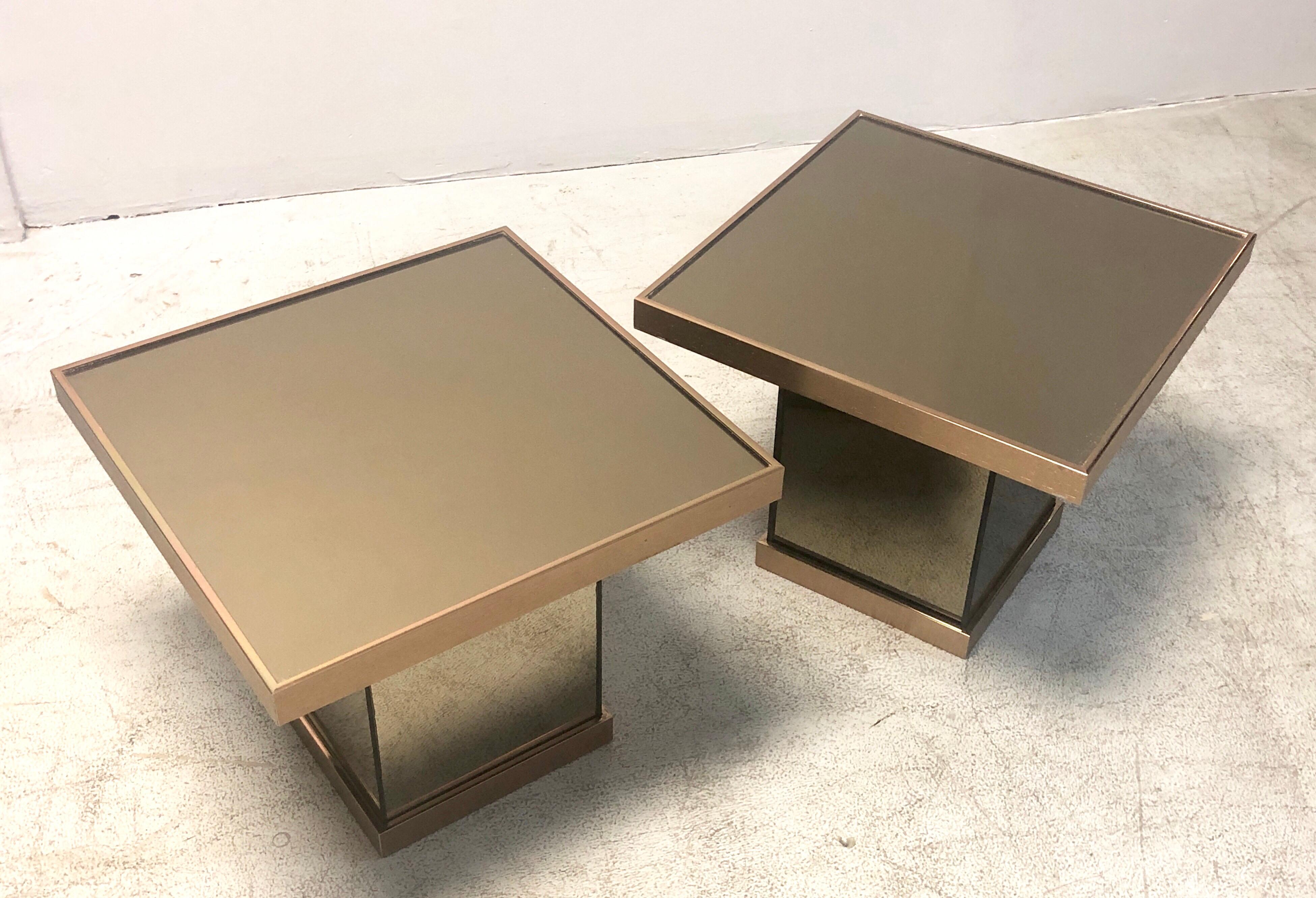 A pair of bronze mirror pedestal tables by Benjamin Martin.