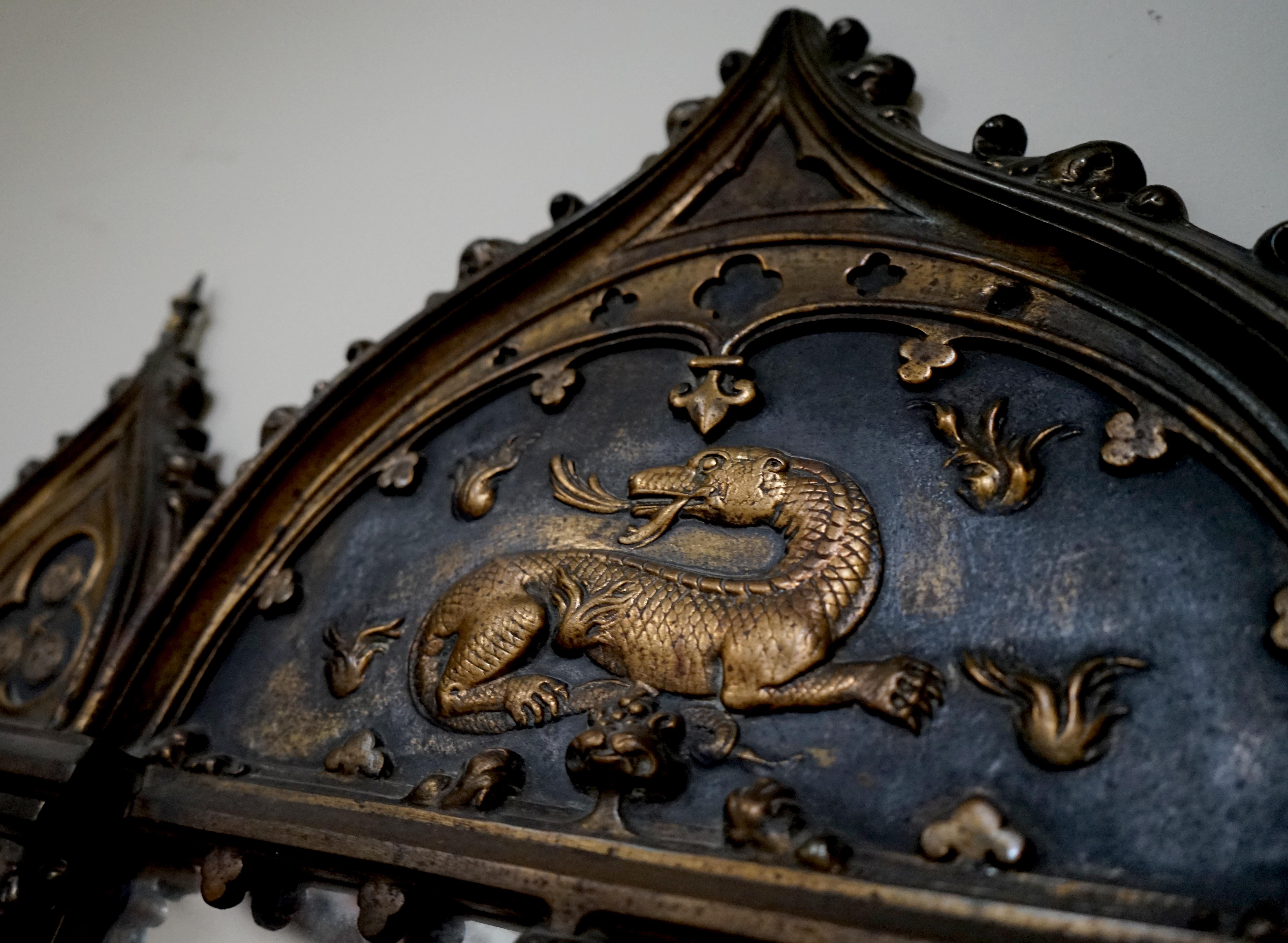 Here we have an outstanding antique bronze mirror. This mirror has two Spanish conquistadors and a dragon as embellishments. Along the bottom are three framed spaces where a portrait has been inserted,

circa 1870

Measurements: 28 3/4