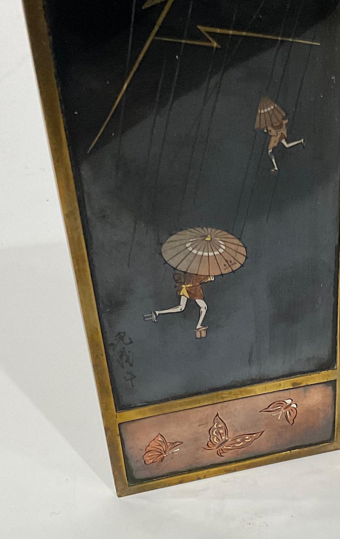 A good Japanese bronze and shakudo miniature table screen, Meiji period, each panel in a gilt bronze frame, one panel depicts figures caught in a rainstorm with lightning, signed lower left, a panel of chrysanthemums, a panel has a female with