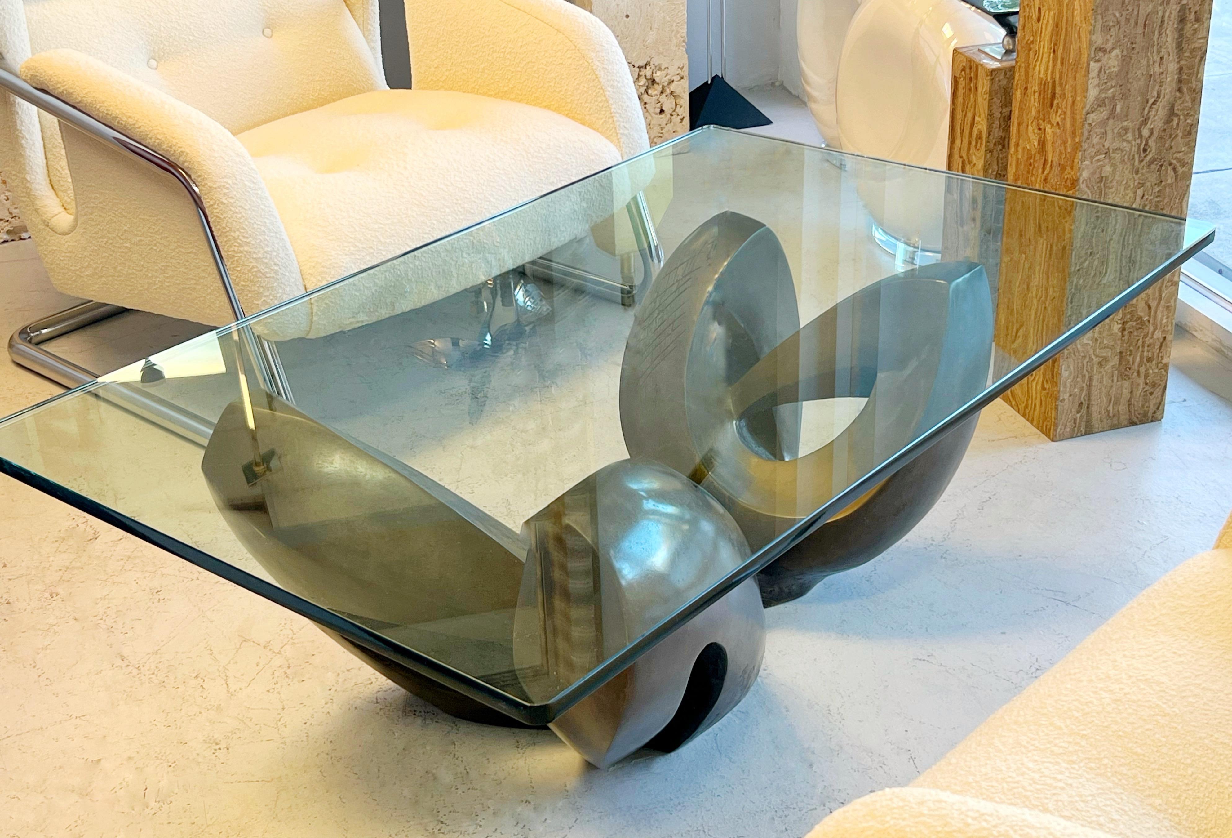Extraordinary sculptural bronze coffee table with glass top. The shape is reminiscent of Barbara Hepworth or Henri Moore sculptures.