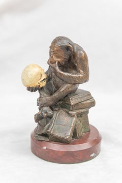Bronze Monkey Holding a Human Skull and a Caliper