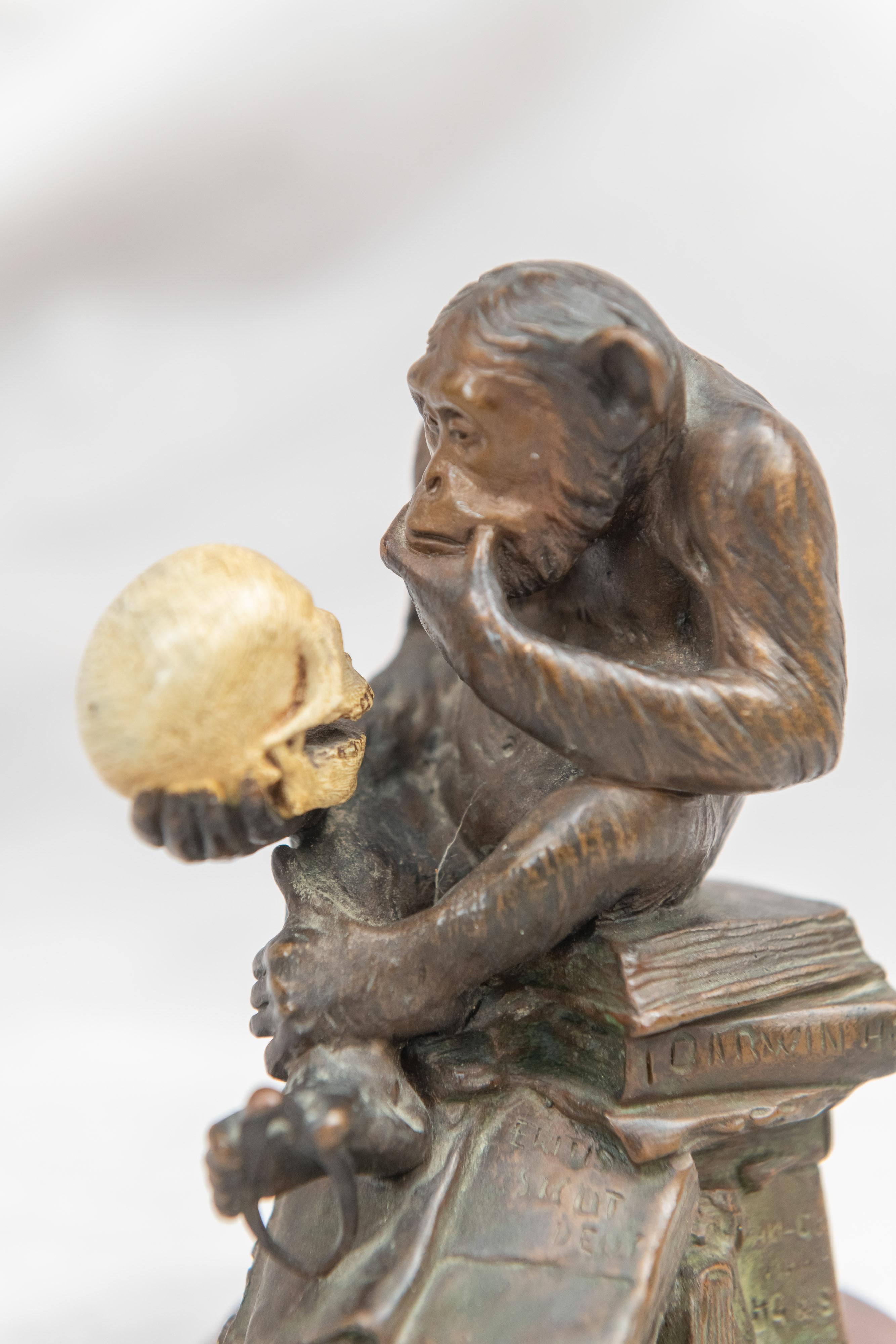 statue of monkey holding human skull