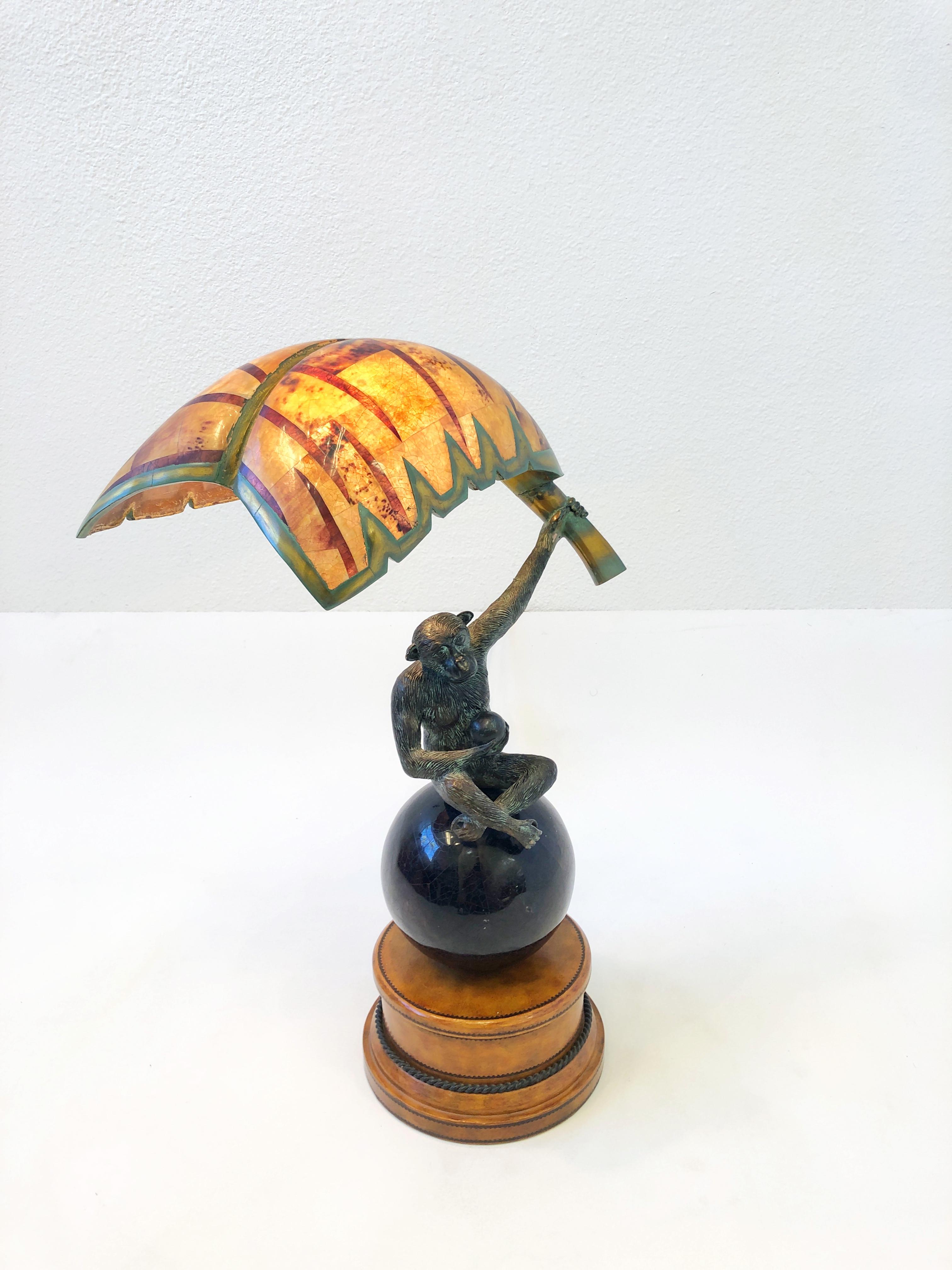 1980’s Bronze Monkey holding a ball and banana leaf on hands table lamp by Maitland Smith. 
Retains Maitland Smith label. 
It takes a 40w max candelabra size lightbulb.
Newly rewired with in line on/off switch.
Measurements: 15” Wide, 9” Deep,