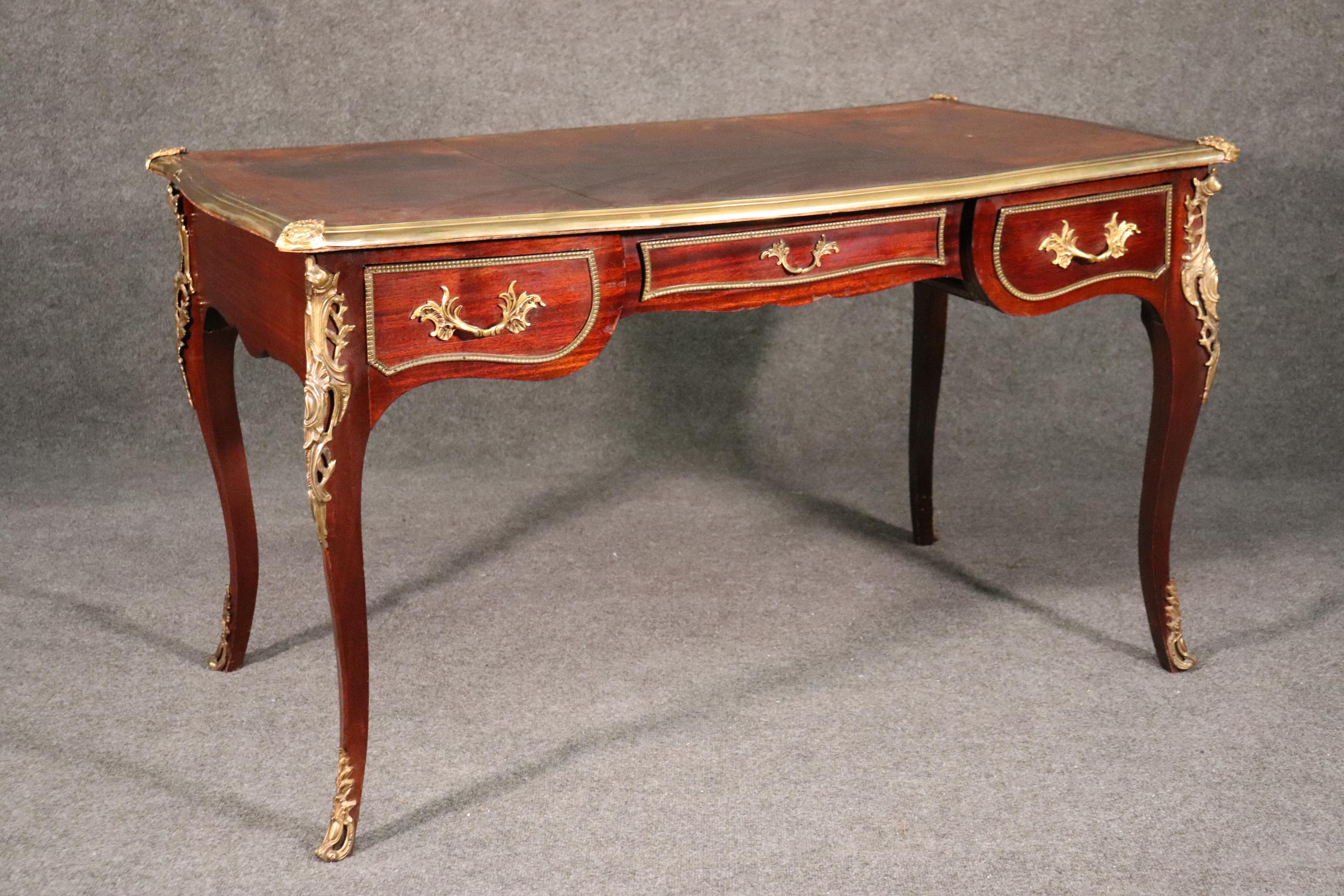 This is a beautifully made French bureau plat with tons of character and time-worn charm. The leather top does have stains from years of use and this really must be accepted or it’s not the right desk for you. If it is the right desk, then you will