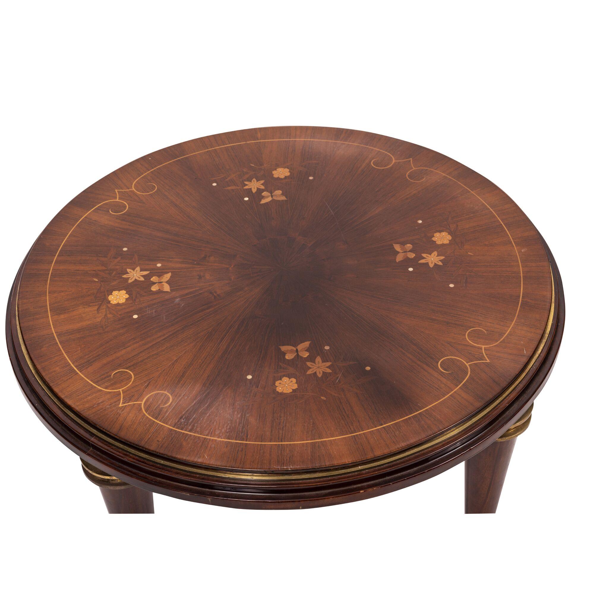 Bronze mounted circular low table, by Jules Leleu.
Rosewood inlaid top having floral and butterfly inlays in a variety of woods and abalone, circa 1925.
Measures: Height 17 5/8 in. (44.76 cm.); Diameter 33 1/2 in. (85.09).
 