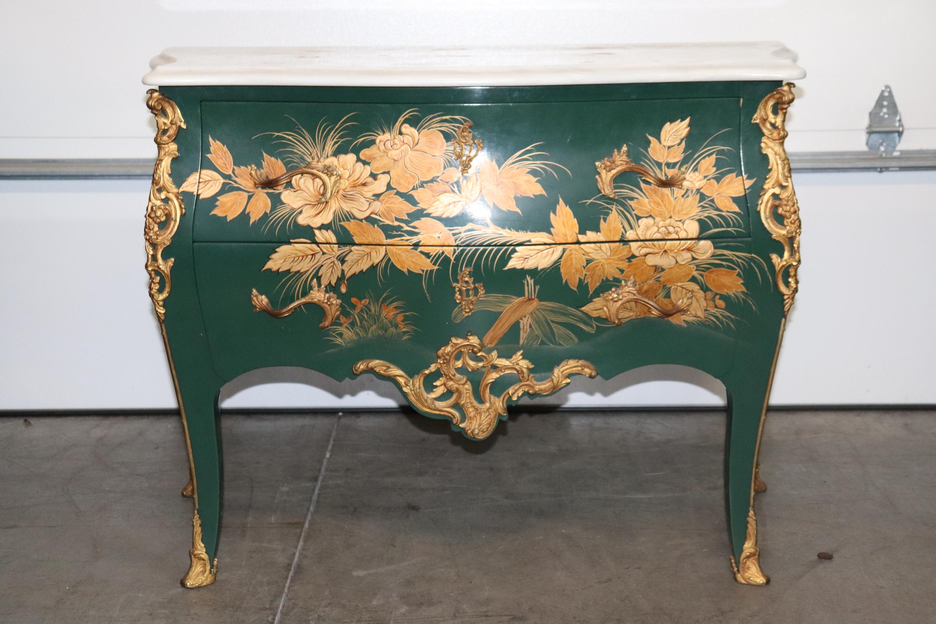 This is a superb green chinoiserie paint decorated commode with a white carrara marble top and a superb gold painted floral decoration which is Actually quite unique because the normal scenery will always be figural, not floral. Sometimes you don't