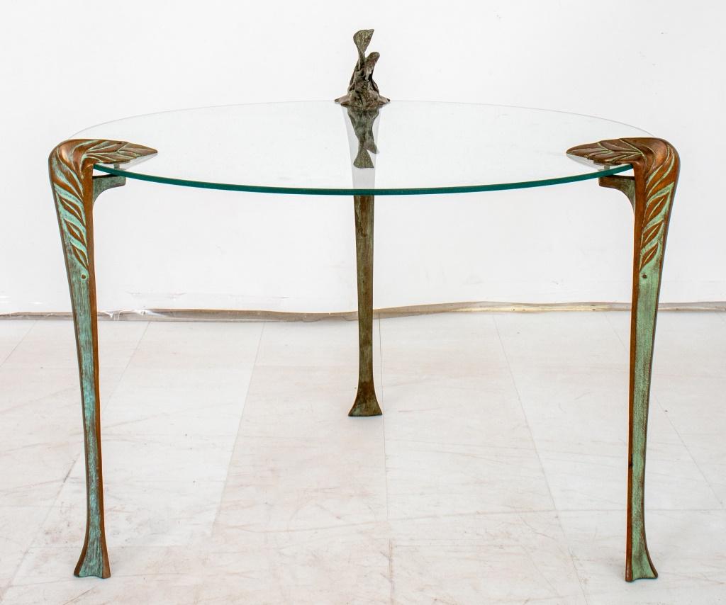 Bronze mounted circular glass end table. the three legs in the form of organic leaf-cast elements, mounted to a circular glass table top, apparently unsigned.

Dealer: S138XX
