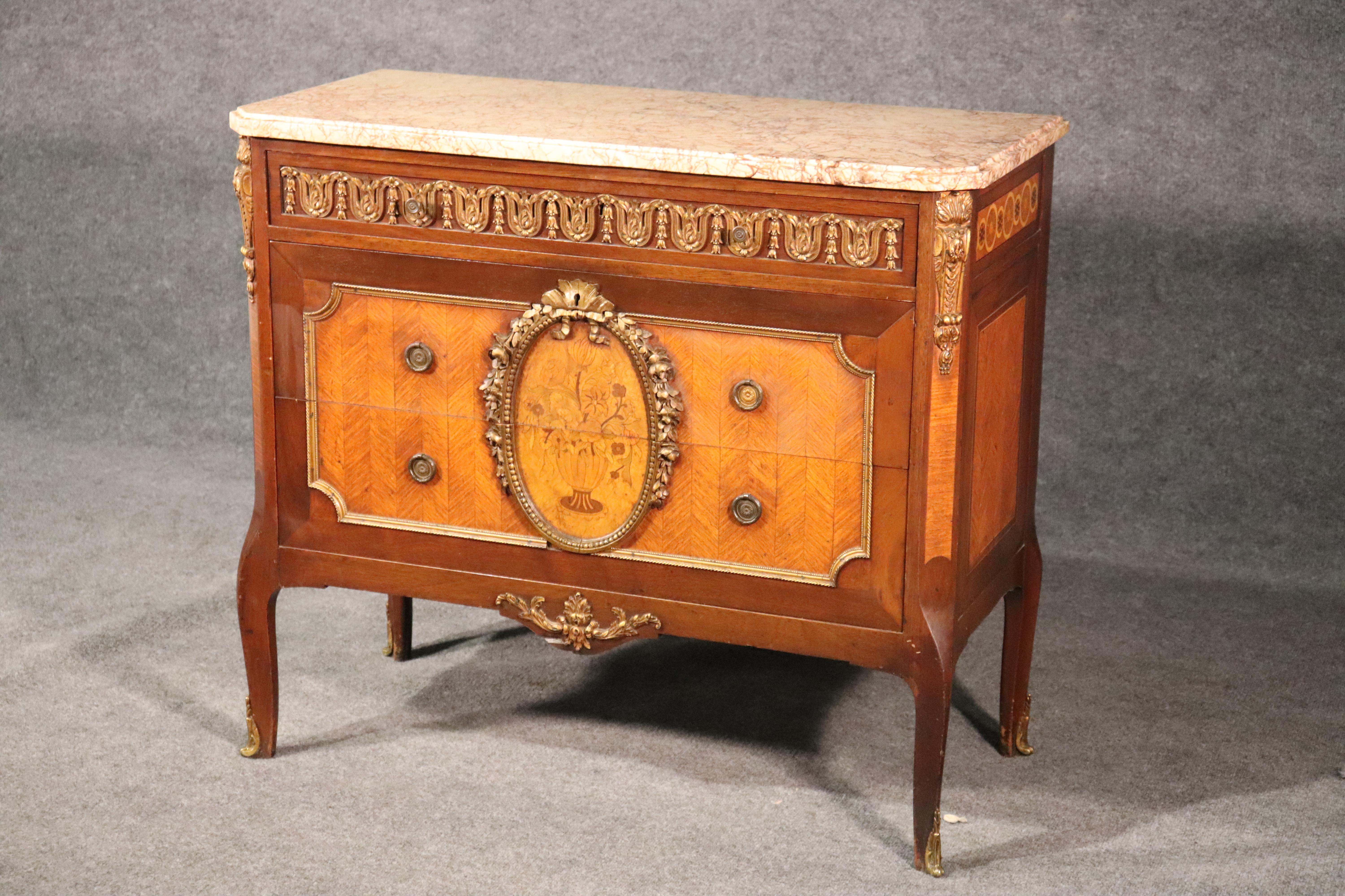This is a superb satinwood and walnut marble-top commode. With beautiful bronze mounts and superb marble on top this piece is in good original condition for a 1920s era piece. 
Measures 34 tall x 39 wide x 18 deep.
 