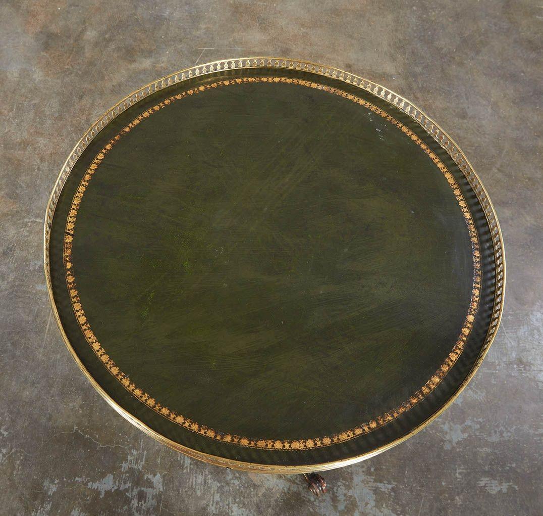 Fine round end table with pierced balustraded brass gallery around gilt-tooled leather top. Striking turned shaft below featuring carved panels with gilt brass beaded trim, the scrolled legs similarly treated and having inset gilt bronze floral