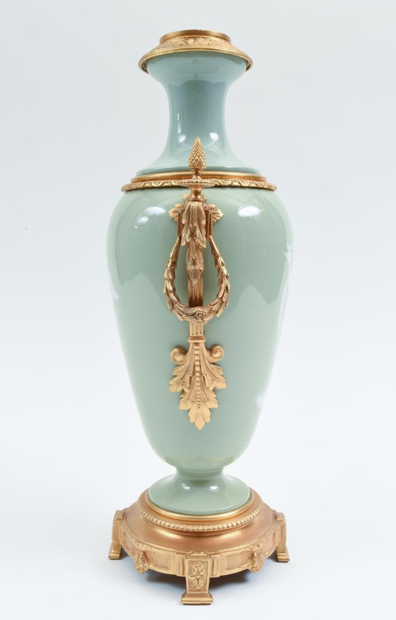 Gilt bronze mounted porcelain decorative piece with exterior design details. The piece is in excellent antique condition. The piece stand about 18 inches high x 10 inches diameter.