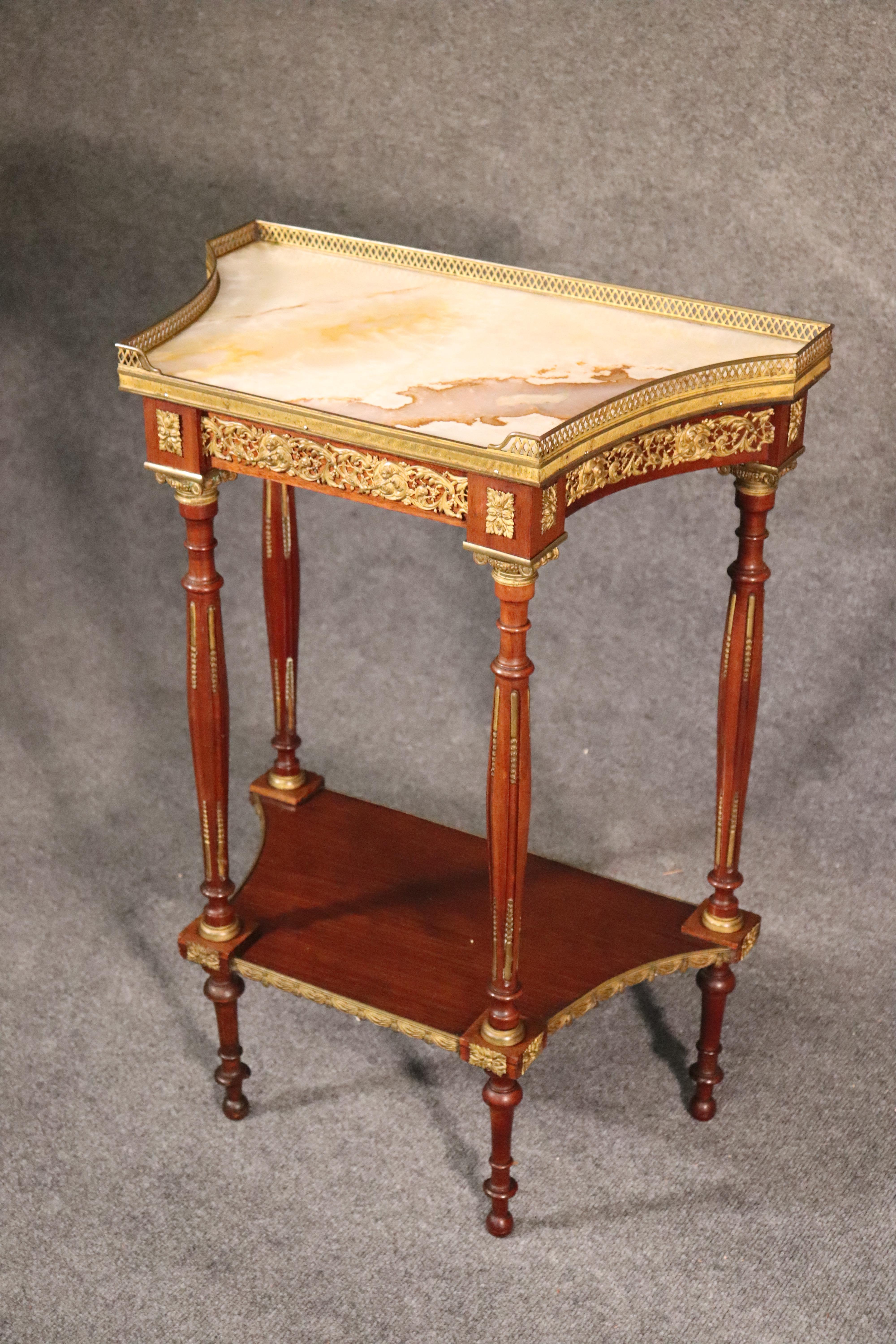 This is a fantastic and beautifully made French end table or plantstand. The table top is translucent onyx and has been professionally repaired so it appears almost perfect. The bronze ormolu is exceptionally well-defined and extremely beautiful.
