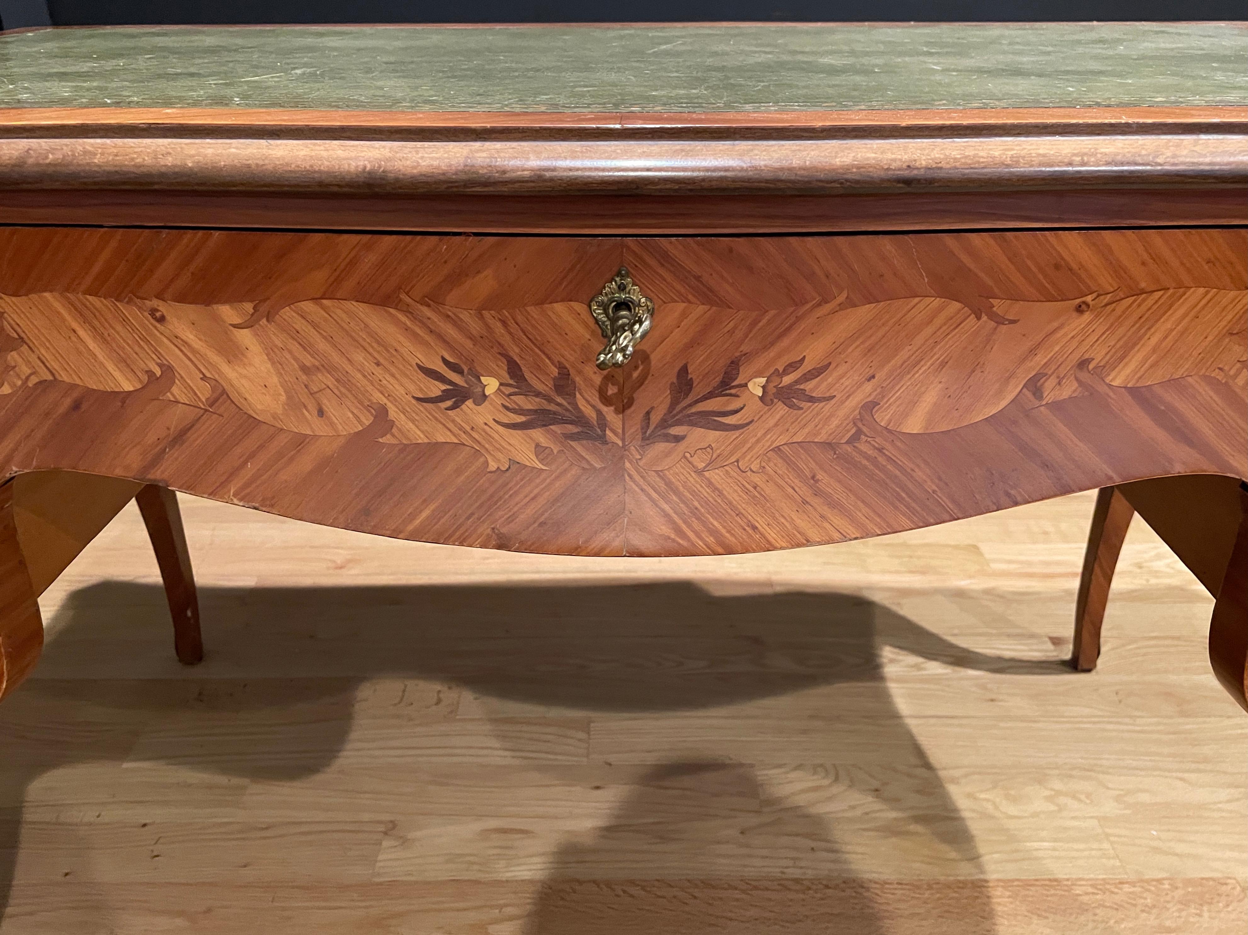 Louis XV Green and gilt tooled leather top bureau plat. Tulipwood and marquetry desk with bronze mounts in Louis XV style.
