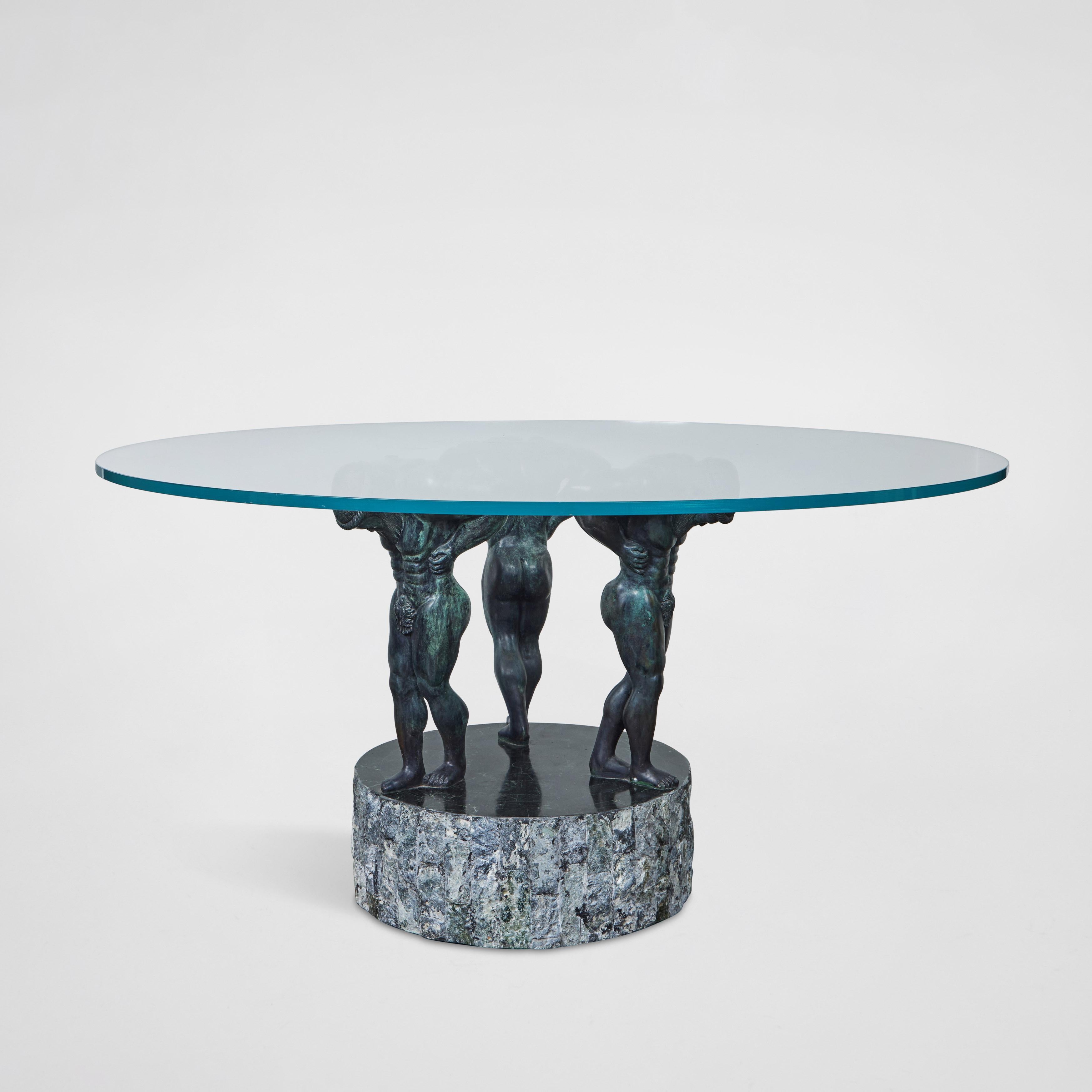 Rare and spectacular table base by Mastercraft, 1980s. The base is comprised of three bronze male figures in a Greco-Roman style standing atop a chiseled, tessillated stone base. The base could be used as either a dining table or center table.