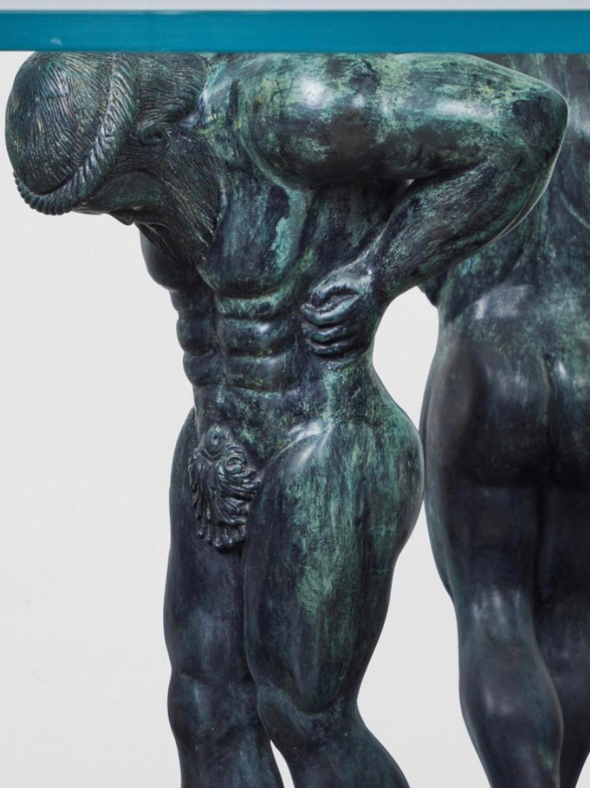 Rare and spectacular table base by Maitland Smith for Mastercraft, 1980s. The base is comprised of three bronze male figures in a Greco-Roman style standing atop a chiseled, tessillated marble stone base. The base could be used as either a dining