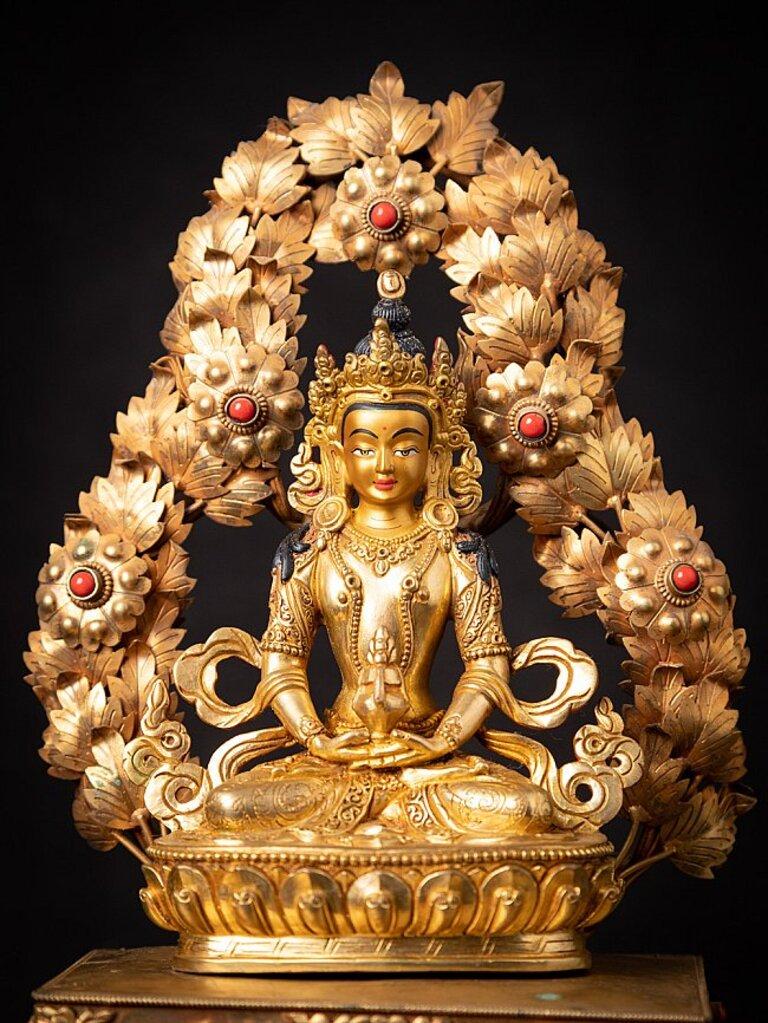 Material: bronze.
Measures: 32, 8 cm high. 
24 cm wide and 18 cm deep.
weight: 1.536 kgs.
fire gilded with 24 krt. gold / the face is gold painted.
Dhyana mudra.
Originating from Nepal.
Newly made in very high quality !
Inlayed with gem
