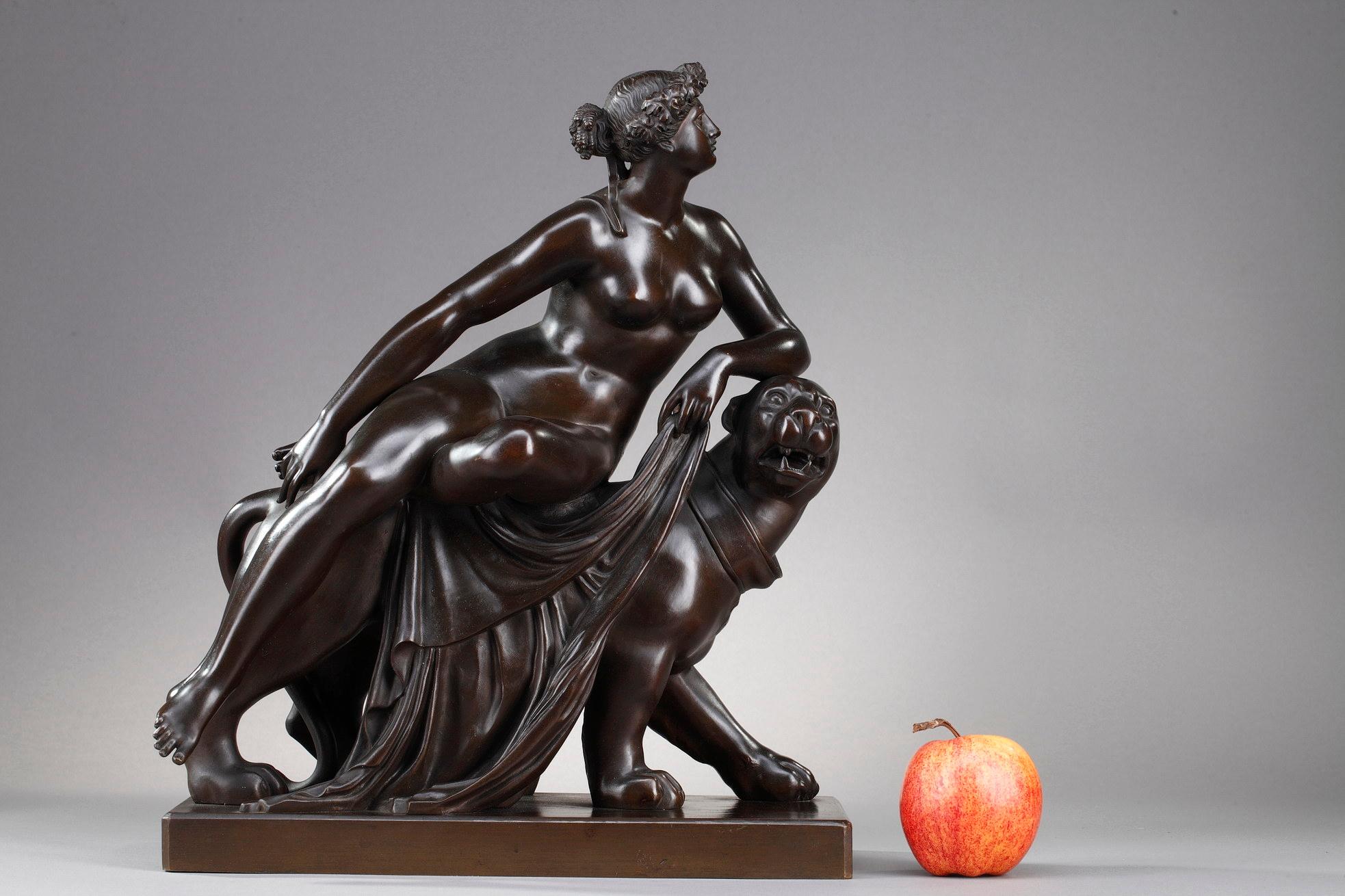 Bronze group representing Ariadne riding a panther after a work by Johann Heinrich Dannecker. It represents a young nude woman wearing a crown of vine leaves as she is the wife of the god of wine Dionysus. She is represented in a calm attitude. It