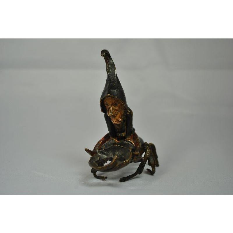 Vienna bronze representing an elf (small humanoid joker) perching on a hoary beetle or lucanus cervus for fastidious entomologists. Size 8 cm by 8 cm. note that a leg is broken.

Additional information:
Material: Bronze.