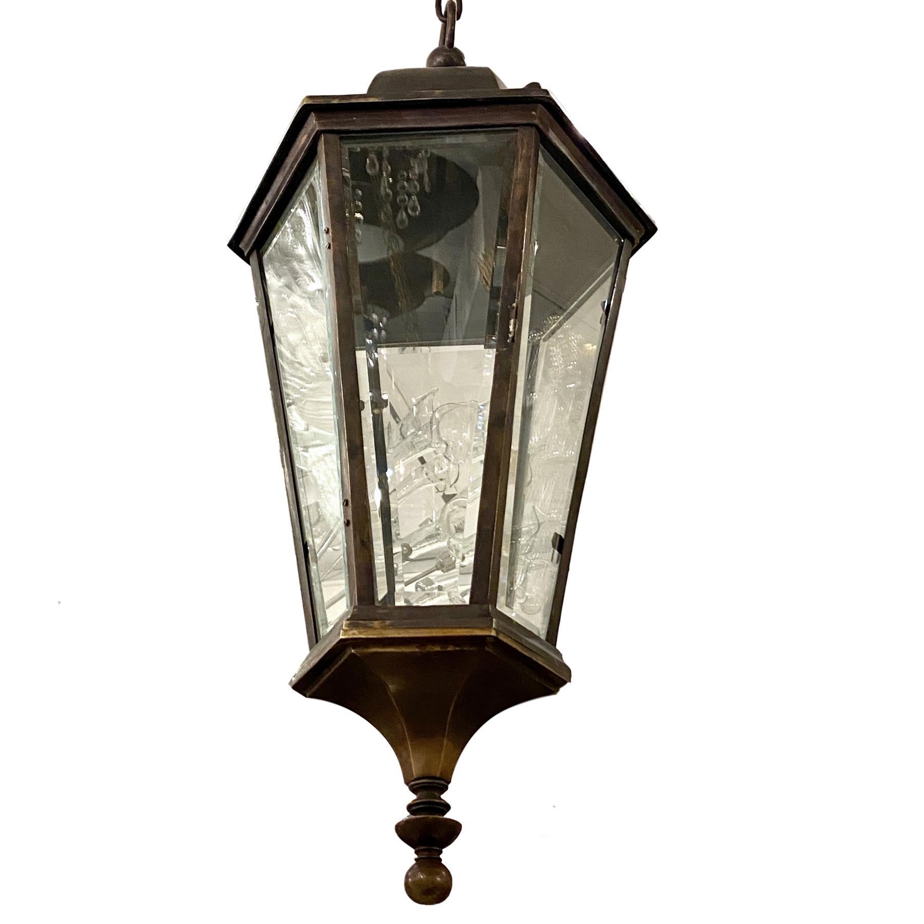 A set of eight circa 1940s English bronze outdoor pendant lantern with interior cluster of candelabra lights. Sold individually.

Measurements:
Height 36