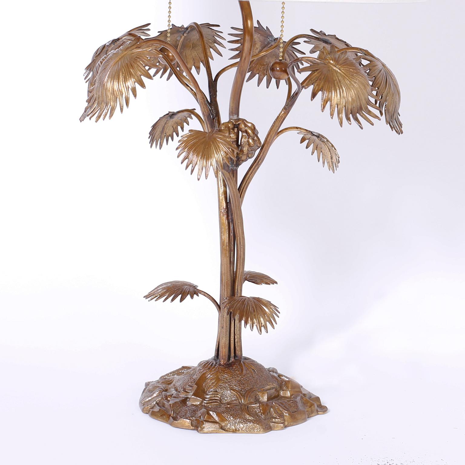 Enchanting tropical table lamp crafted in bronze depicting a stylized palm tree on a faux terra firma base.