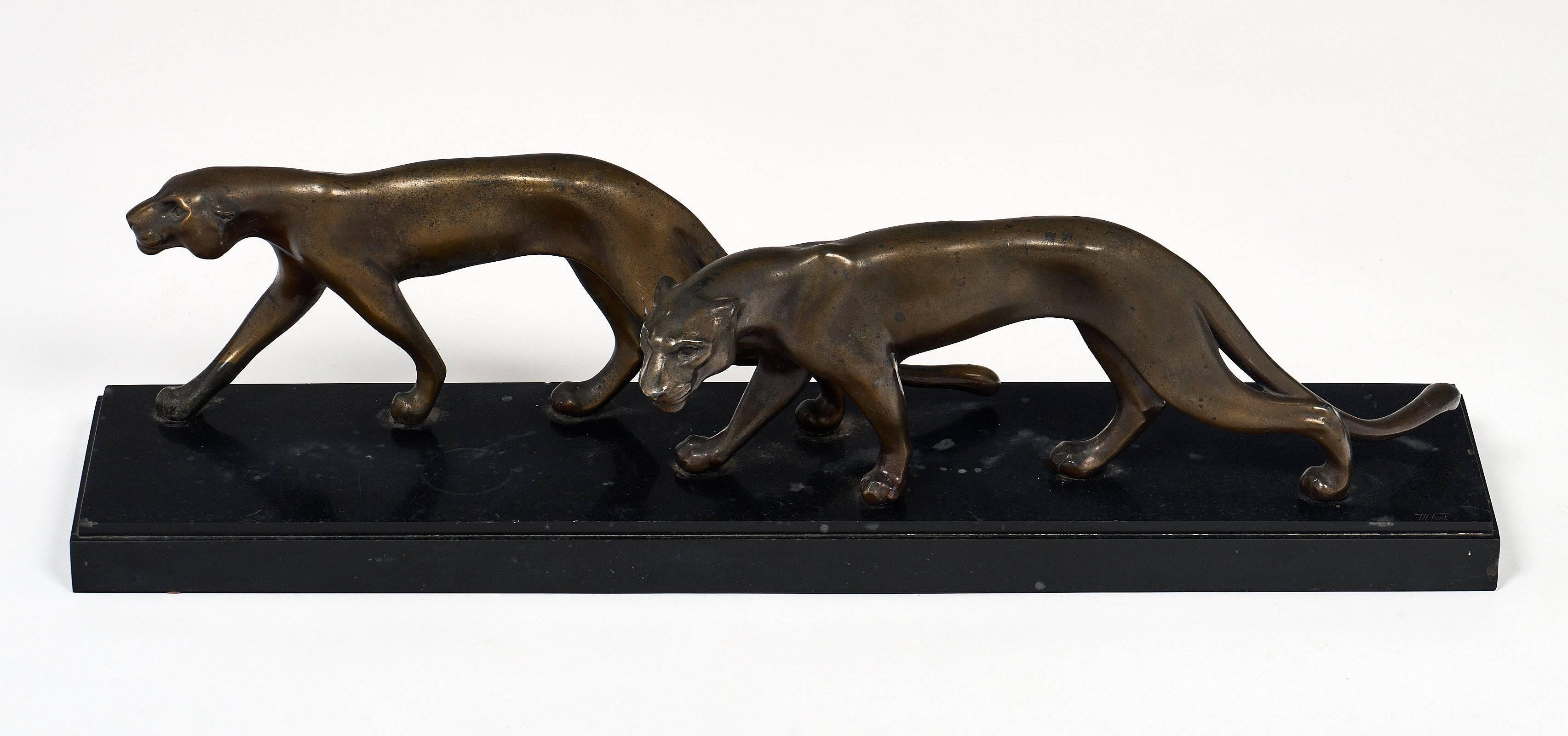 Art Deco period bronze panther statue featuring two stylized panthers walking. We loved the original patina and the refined quality of the cast. There is an overall allure of this bronze piece!