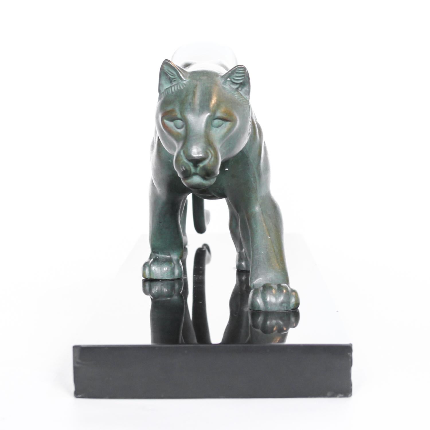 An Art Deco, patinated spelter study of a prowling panther, mounted on a black marble base. Signed 'M. Leduc' to hind leg. Minor chips to base.



