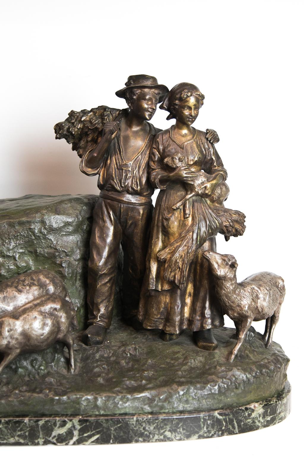 Bronze pastoral figure group, depicting goats, lambs, and a couple. The woman is holding a lamb, while the man is holding harvest. It is on a Verde marble base.