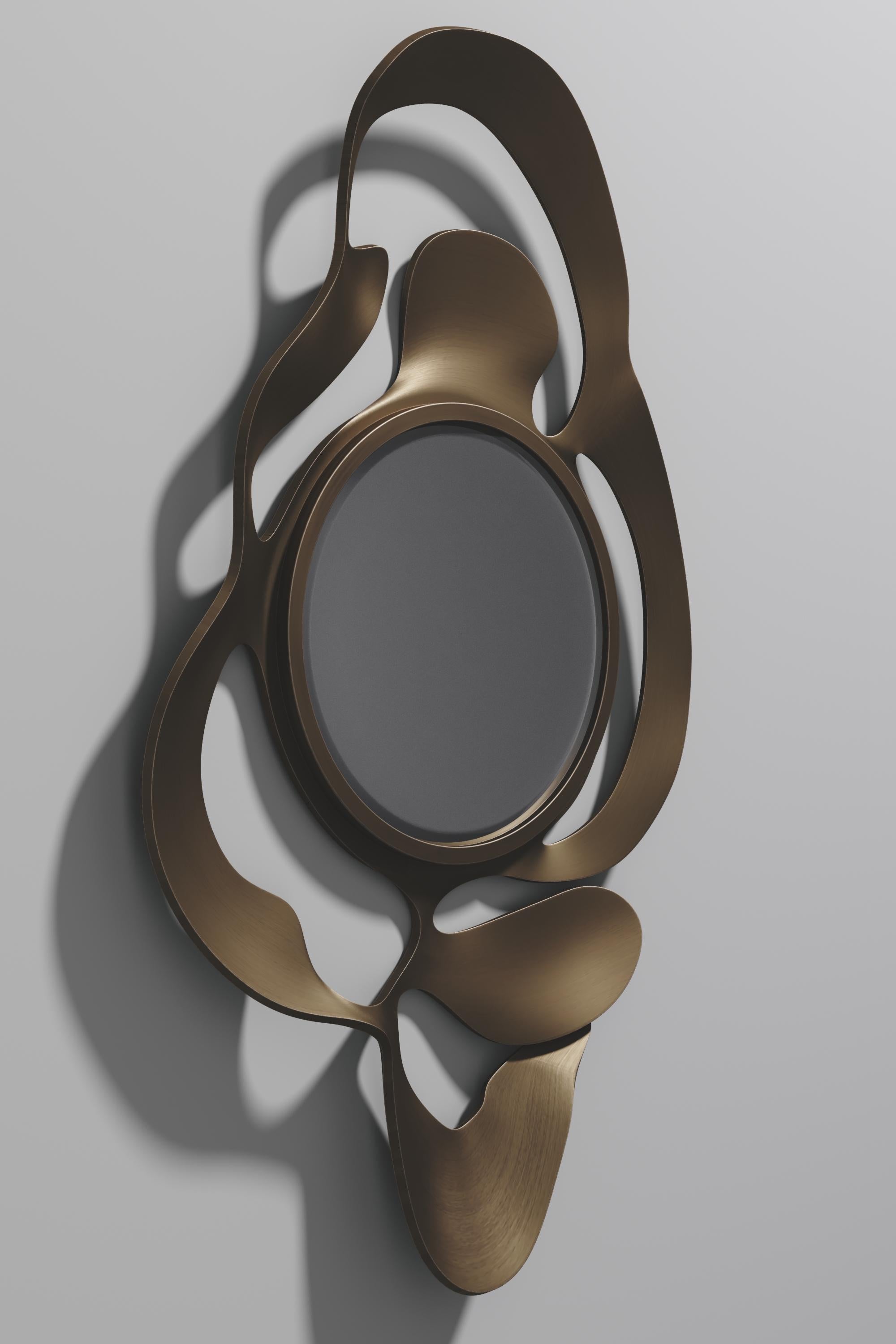 The Leaf Mirror by Kifu Paris is a dramatic and organic piece. The black pen shell and bronze-patina bass inlay mixture creates a striking appearance as it emulates a whimsical interpretation of intertwining branches. This piece is designed by Kifu