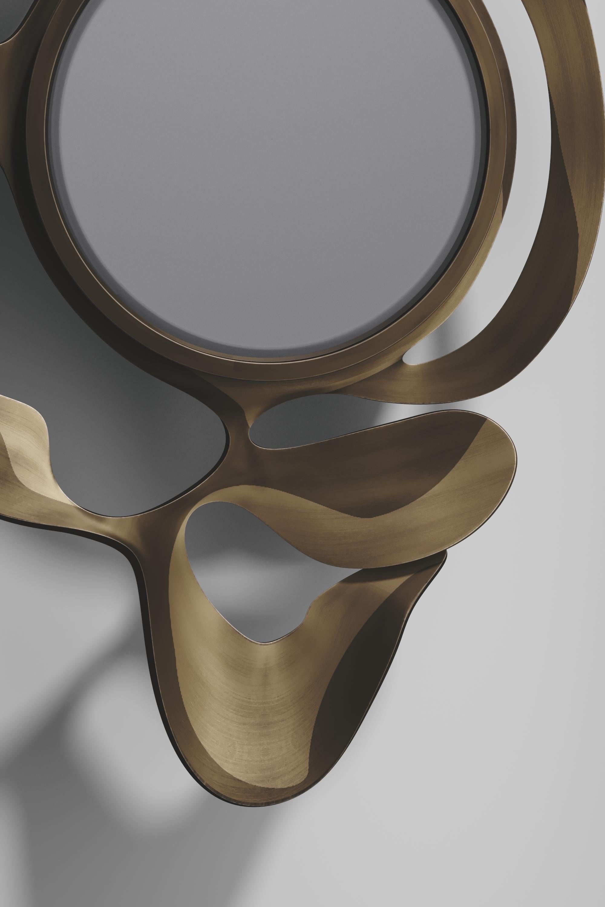 The Leaf Mirror by Kifu Paris is a dramatic and organic piece. The two tone bronze-patina bass inlay mixture creates a striking appearance as it emulates a whimsical interpretation of intertwining branches. This piece is designed by Kifu Augousti