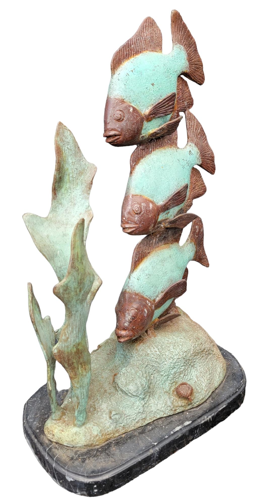 Bronze Patinaed Tall Fish statue. Wonderful Green coral like color with a mutes gray. Wonderful patina to the sculpture. great height and weight. Measures approx - 27h x 16d x 10.5w
