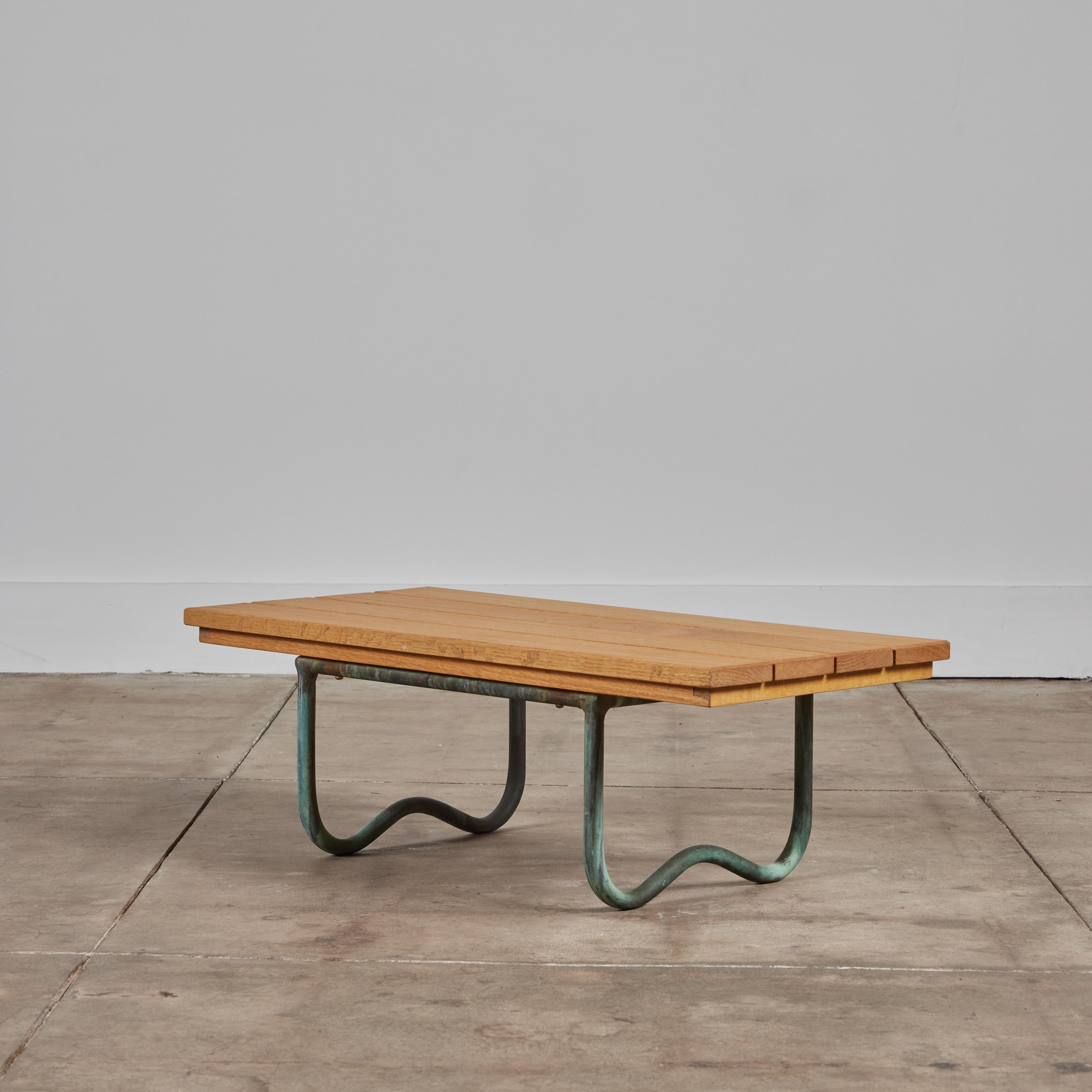 The WT-3715 Beach Table designed by Walter Lamb for Brown Jordan features a tubular bronze frame and a new oak slatted wood tabletop. Recalling Lamb’s earlier work, the table has molded curves in the runners that act as the feet of the piece.

The