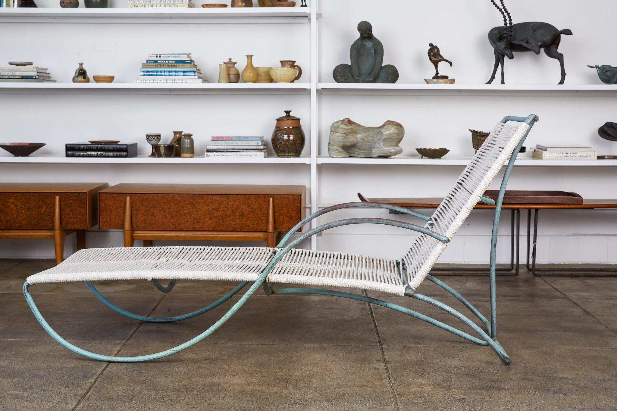 A single S-lounge patio chair by Walter Lamb for Brown Jordan. Graceful even for a Lamb design, the chaise lounge is rendered in bronze tubing with a seat of woven yacht cord. Its namesake armrest draws a serpentine curve from the backrest to the