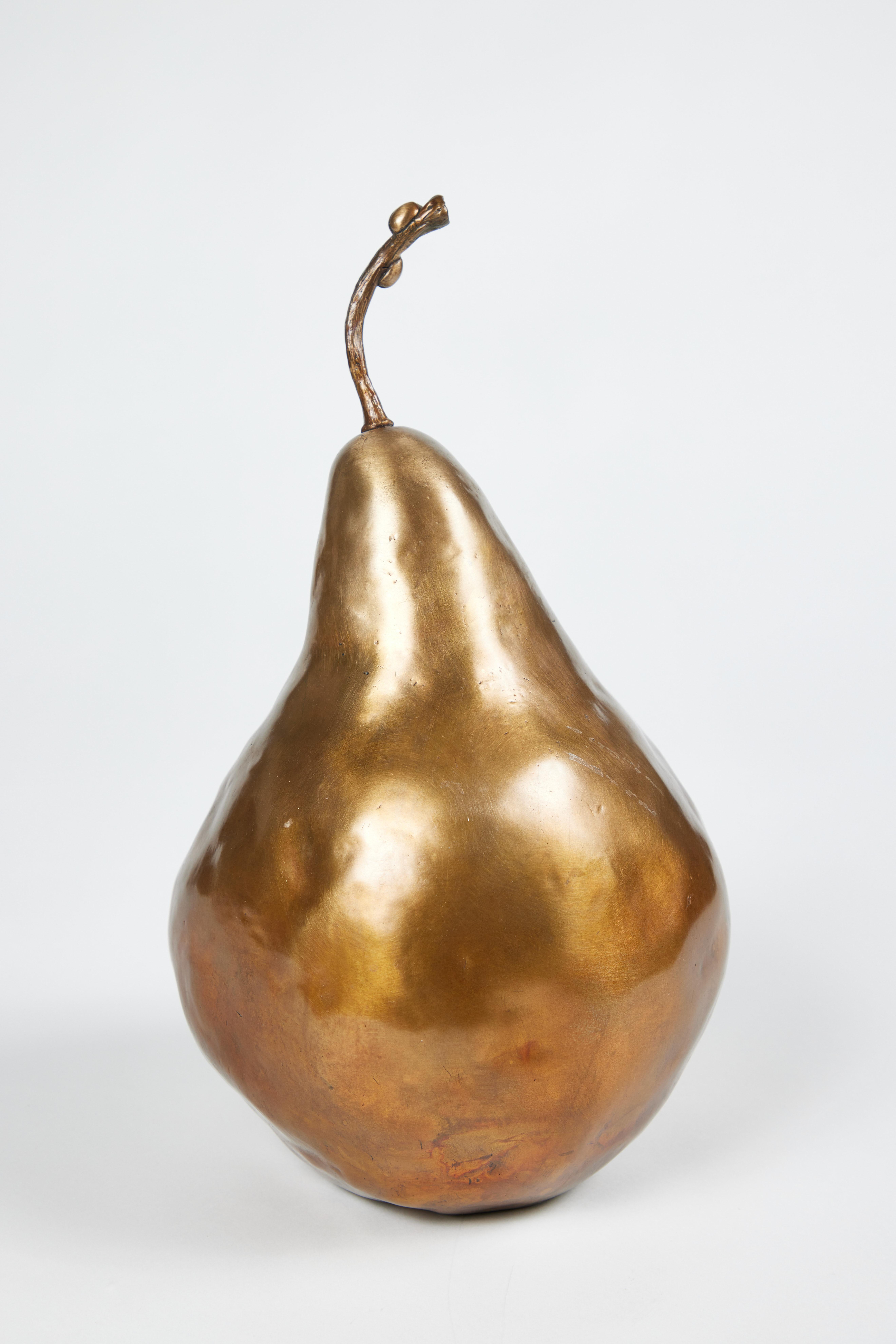 Bronze sculpture depicting a pear with two ladybugs on the stem. Signed and numbered 12/30 along the base.