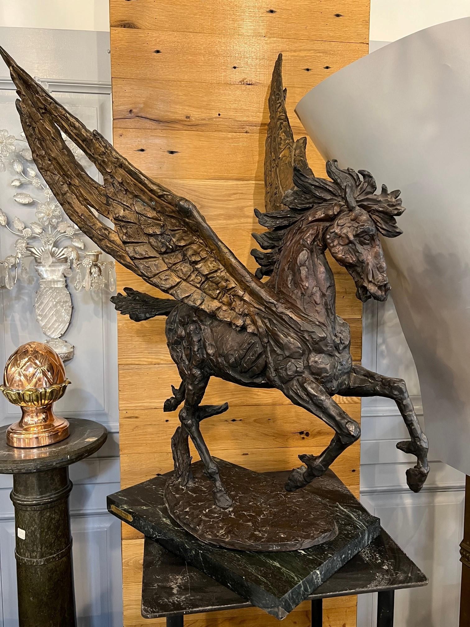 Intricately detailed mythological winged Pegasus with variations in patina throughout. Stands on a contemporary marble base. This large stallion with wings is bronze and signed by Laszlo Ispanky. Pegasus' have been a mainstay of fantasy art and