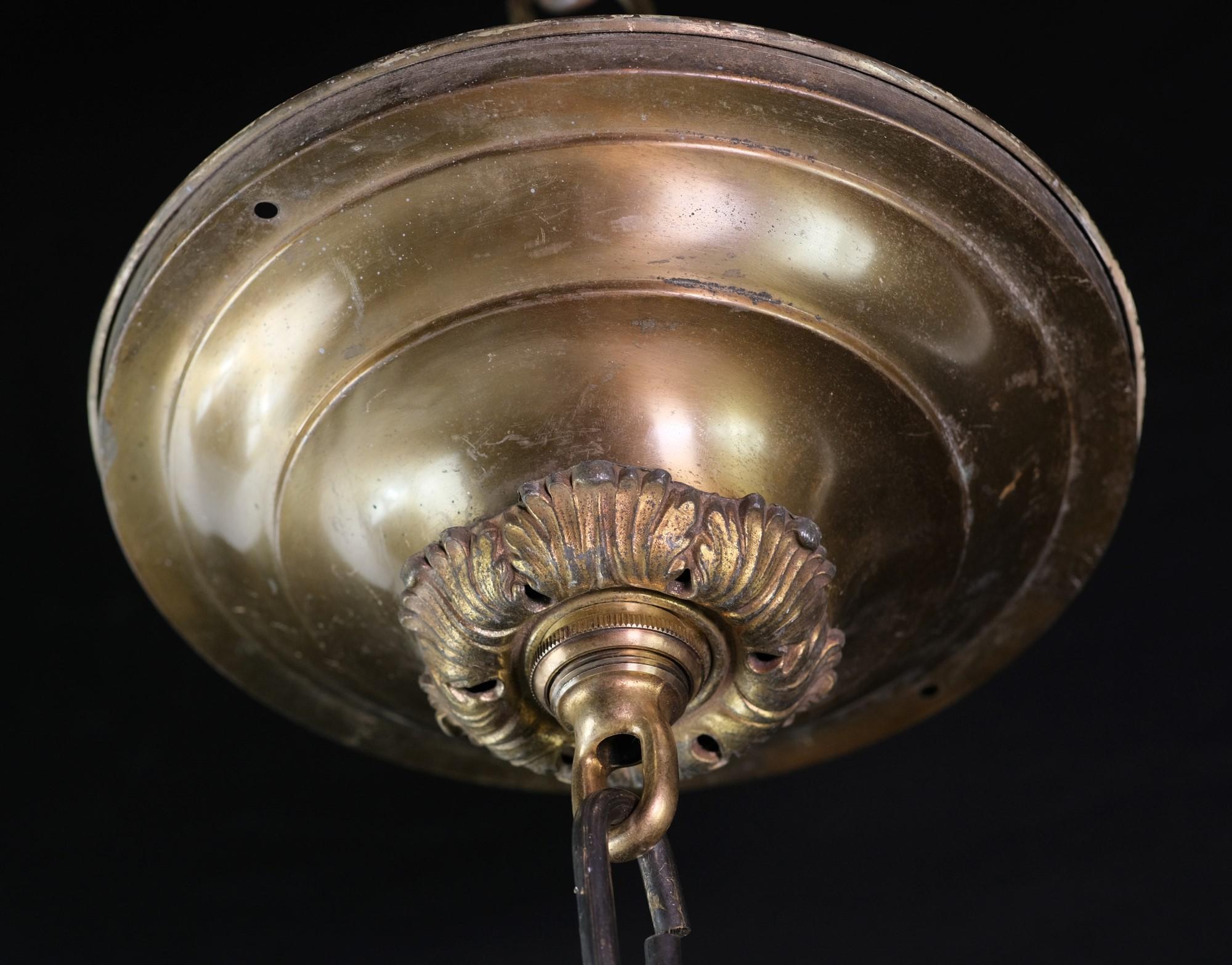 Ornate aged bronze fitter, a matching steel chain and a brass mount make up the hardware part of this pendant light. Comes with the original spherical frosted glass shade. Small quantity available at time of posting. Priced each. Please inquire.