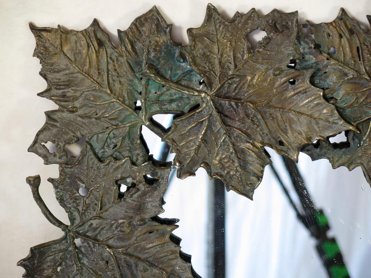 Very beautifully-crafted and unusual mirror with a large bronze frame made of a frieze of realistic-looking plane tree leaves, with a Verdigris patina.