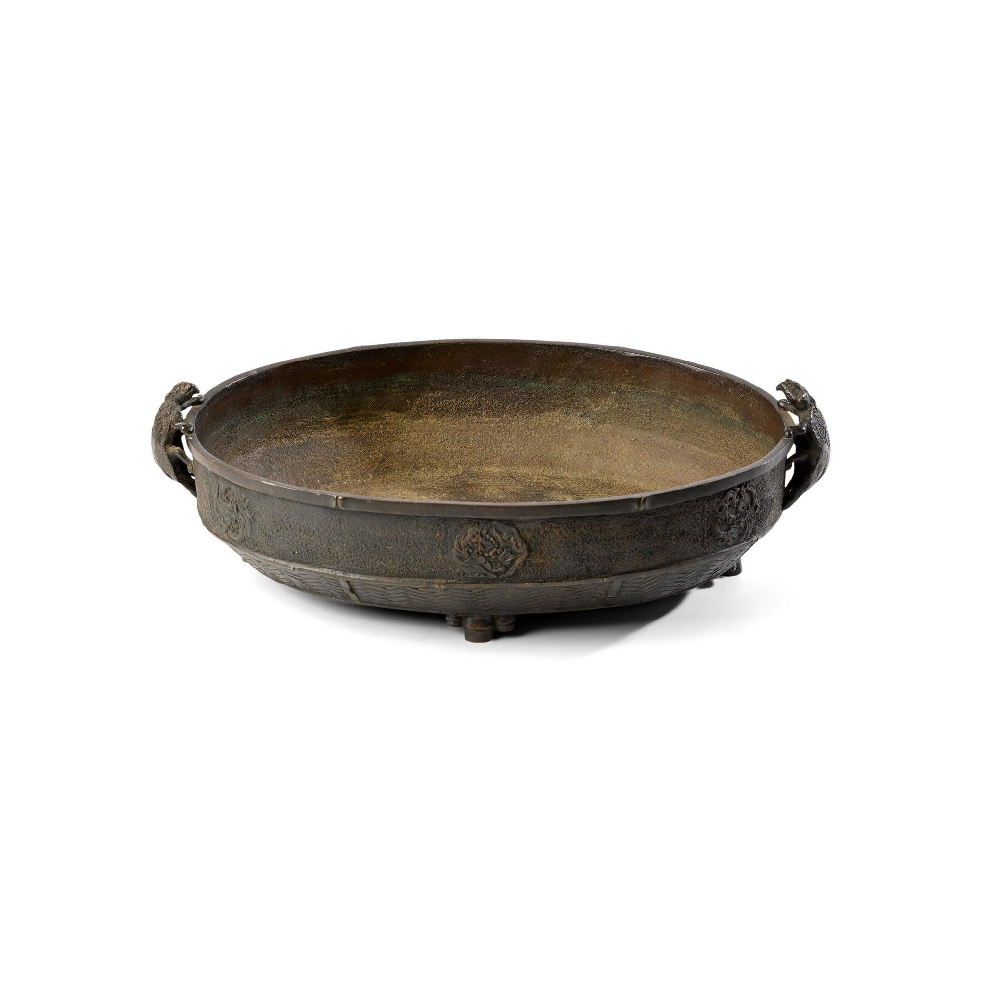 A vintage shallow bowl with pattern and texture designed to mimic a contrasting material to the bronze of which this bowl is cast from.