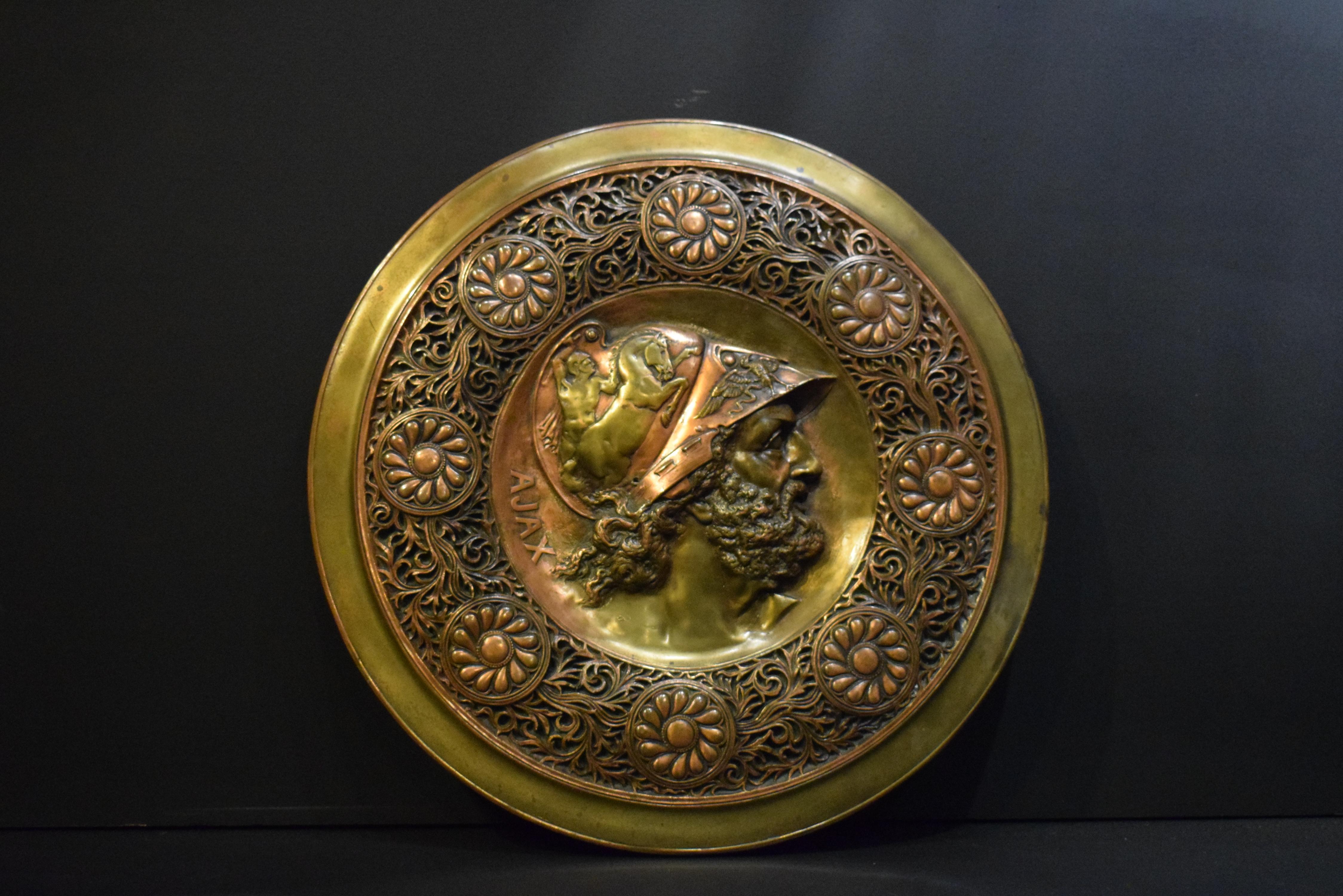 A superb gilt bronze plaque of great quality depicting the Greek warrior 