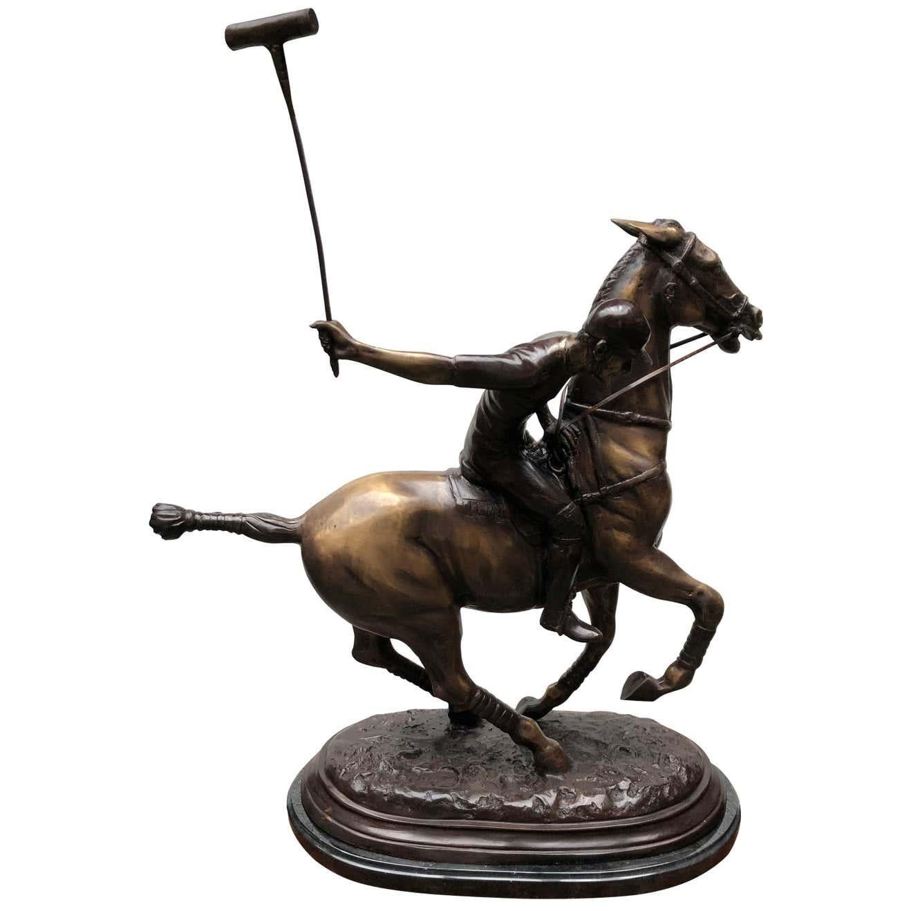 A stunning English bronze casting of a polo player in full swing. Artist has really captured the energy and athleticism of the scene with great skill. Patina to the bronze is superb with various brown hues. Piece sits on a black marble base which is