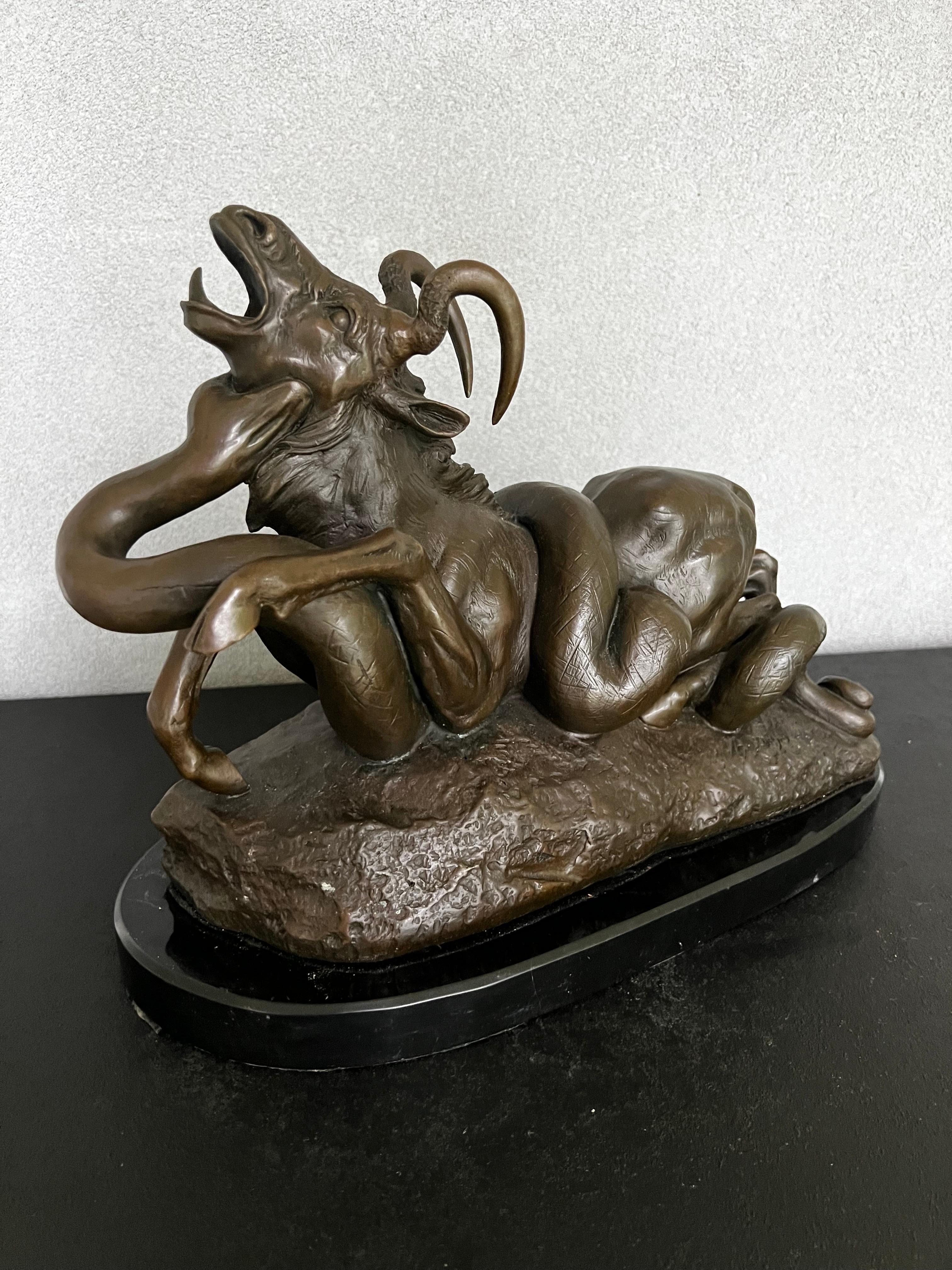 Magnificent high quality reproduction of Antoine-Louis Barye‘s famous Python Killing Gnu, cast in bronze with a 1” black marble base. This piece it’s large and heavy and would be and statement piece in any room. Would look perfect on a fireplace