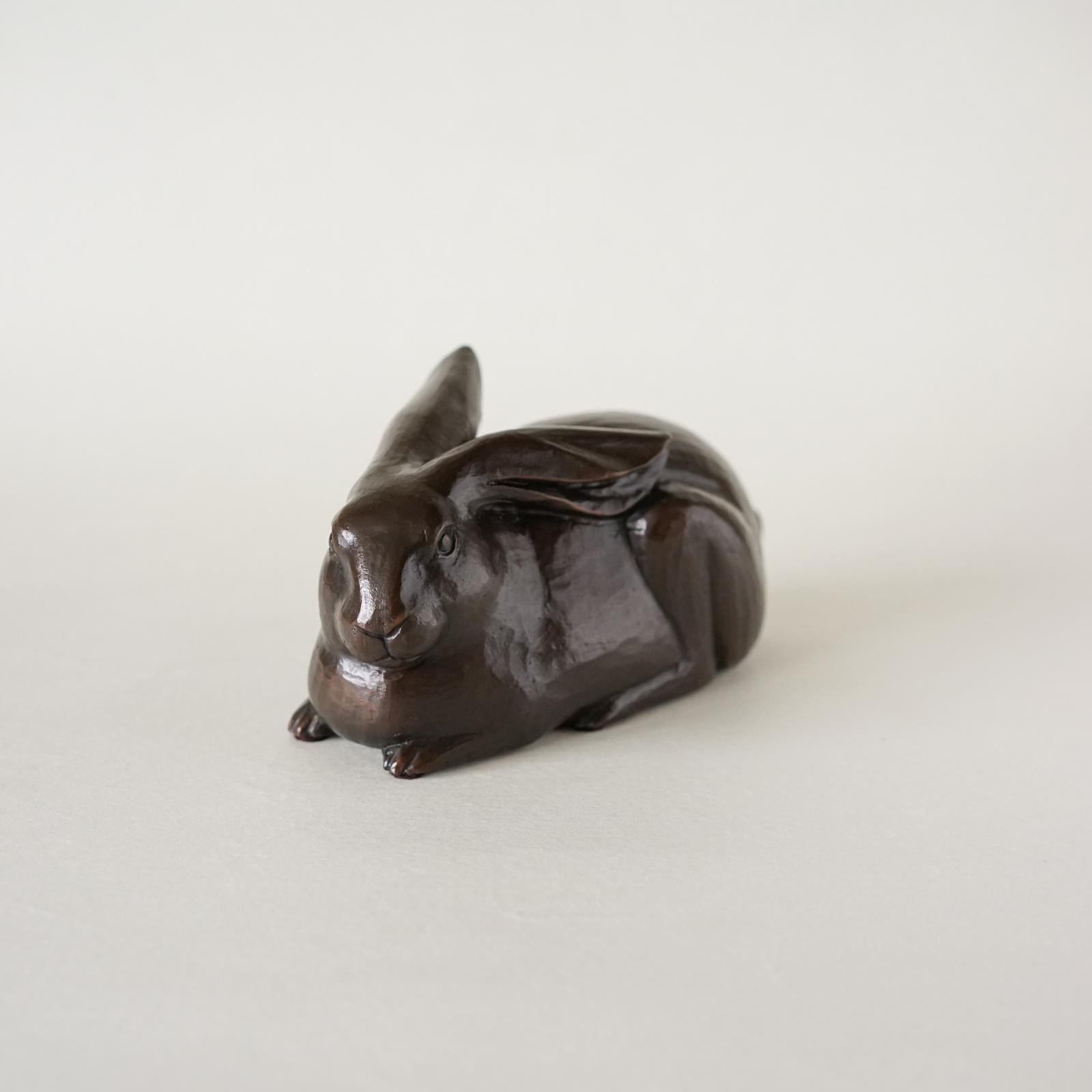 The rabbit is a symbol of wit, prudence and skill, of abundance and good fortune. It is cast in a rich dark bronze patina to make a charming gift for the season, a beautiful object for the desk or vanity that is warm and smooth when held in the